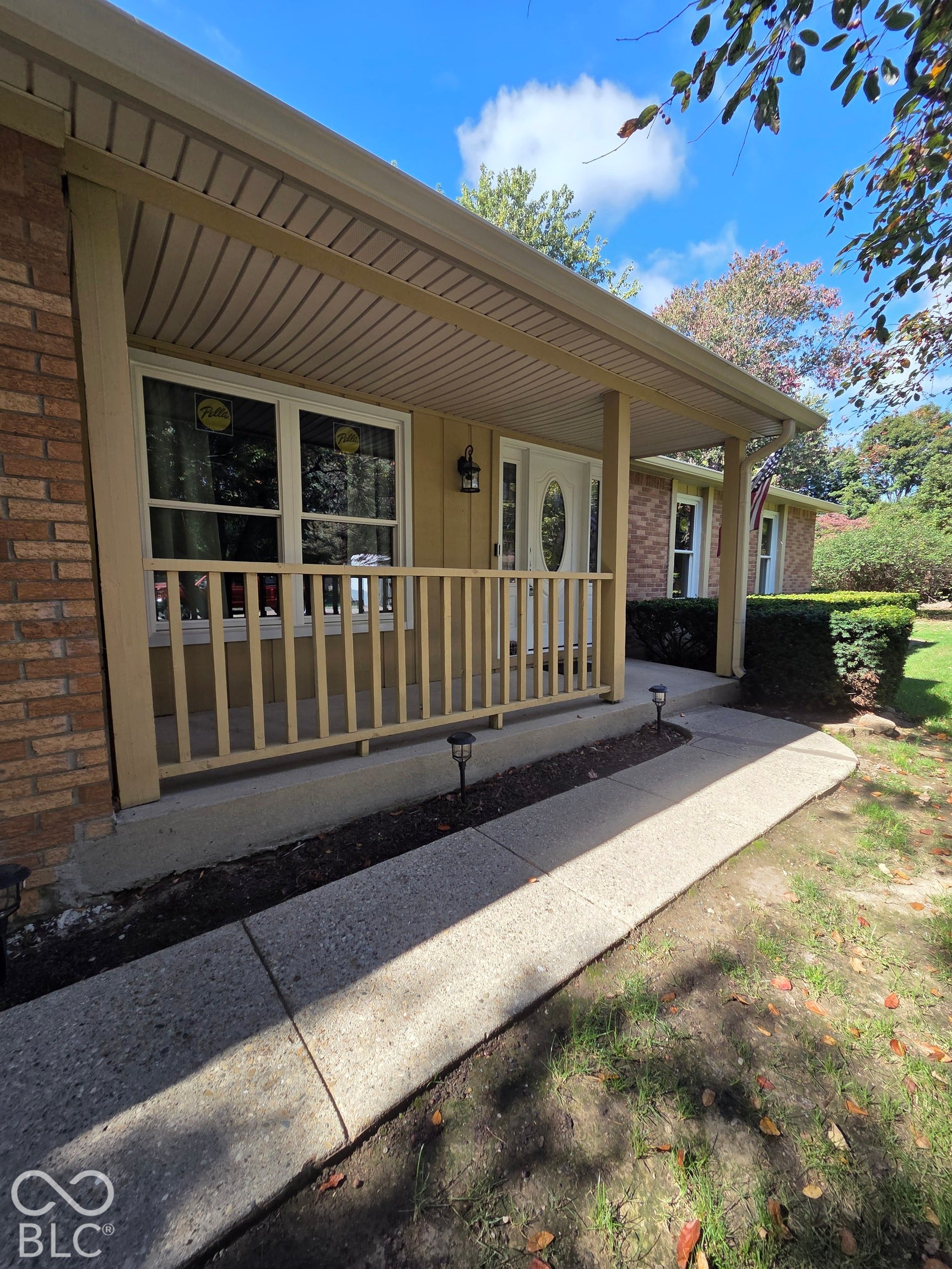 6614 Weil Drive, Brownsburg, IN 46112 Covered front porch with wood railing.
