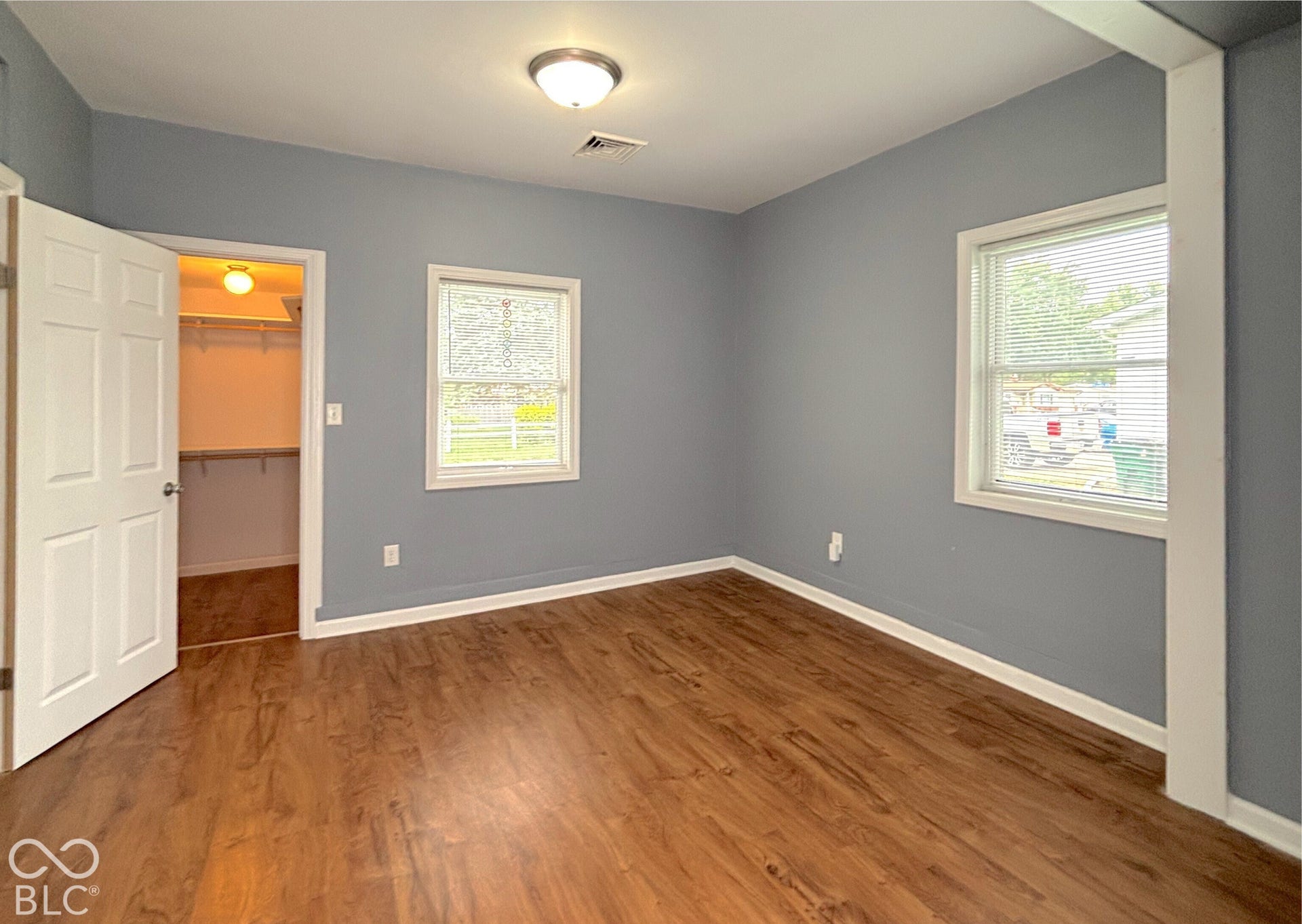 311 B Street S, Thorntown, IN 46071 Wood-finish flooring, two windows with white trim, built-in closet with shelving, and overhead lighting