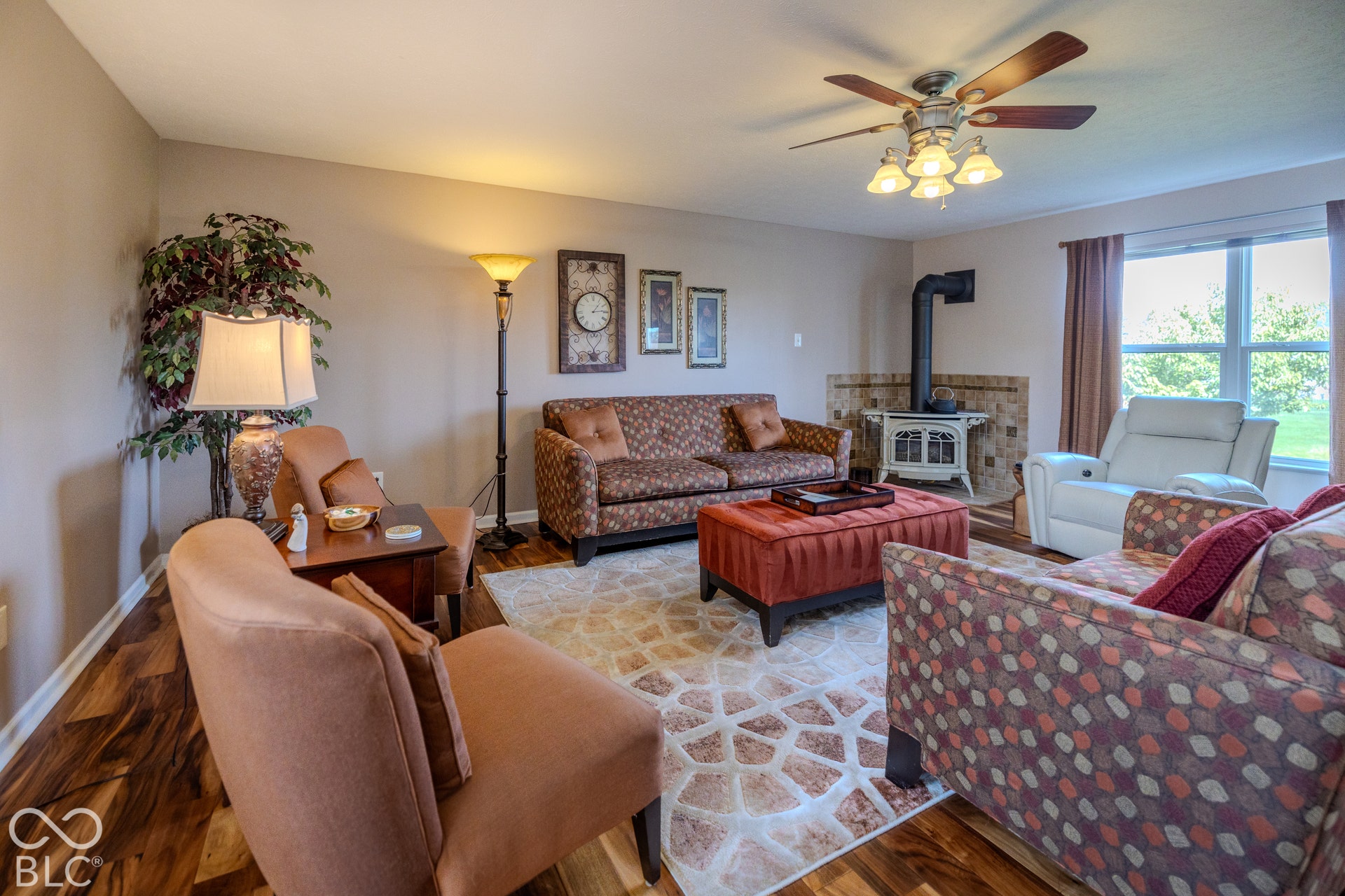 12046 Cowboys, Fishers, IN 46037 The family room has large windows that let in an abundance of natural light and offers great pond views. The wood stove with glass doors actually adds heat to the room.