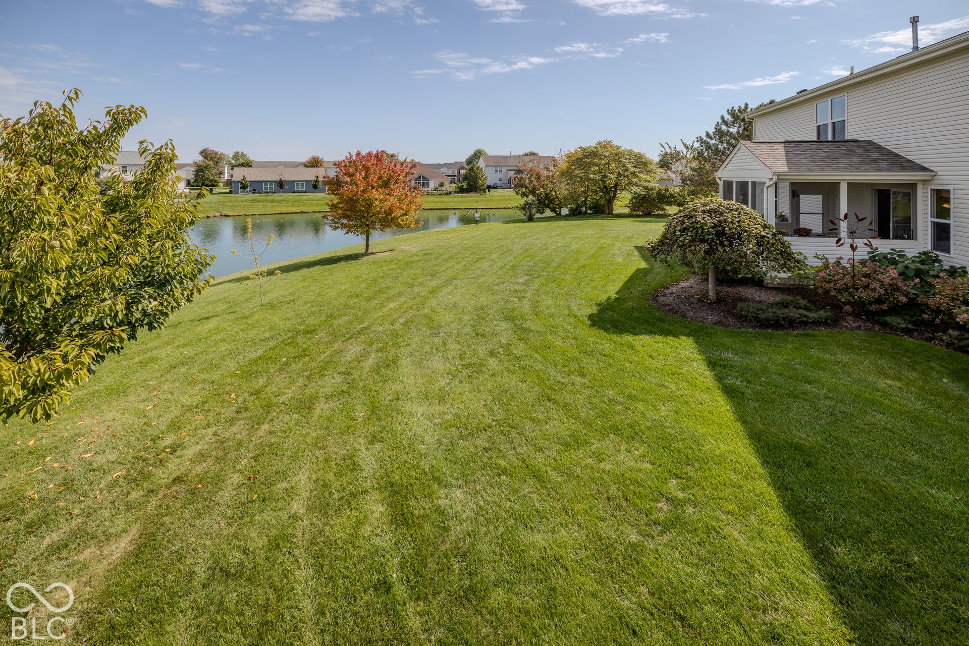 12046 Cowboys, Fishers, IN 46037 Expansive lawn leading to a tranquil pond