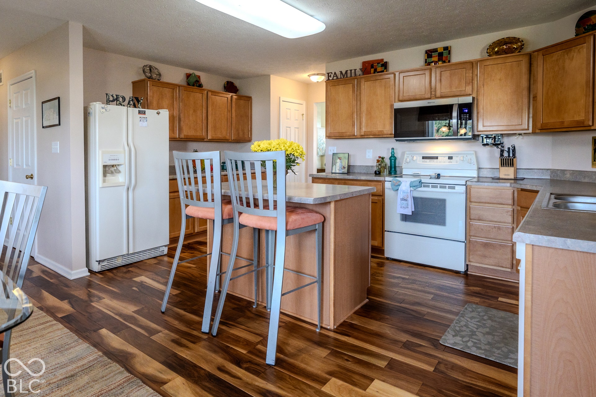 12046 Cowboys, Fishers, IN 46037 The kitchen offers a center island/breakfast bar and abundant counter space and gleaming engineered hardwood floors.