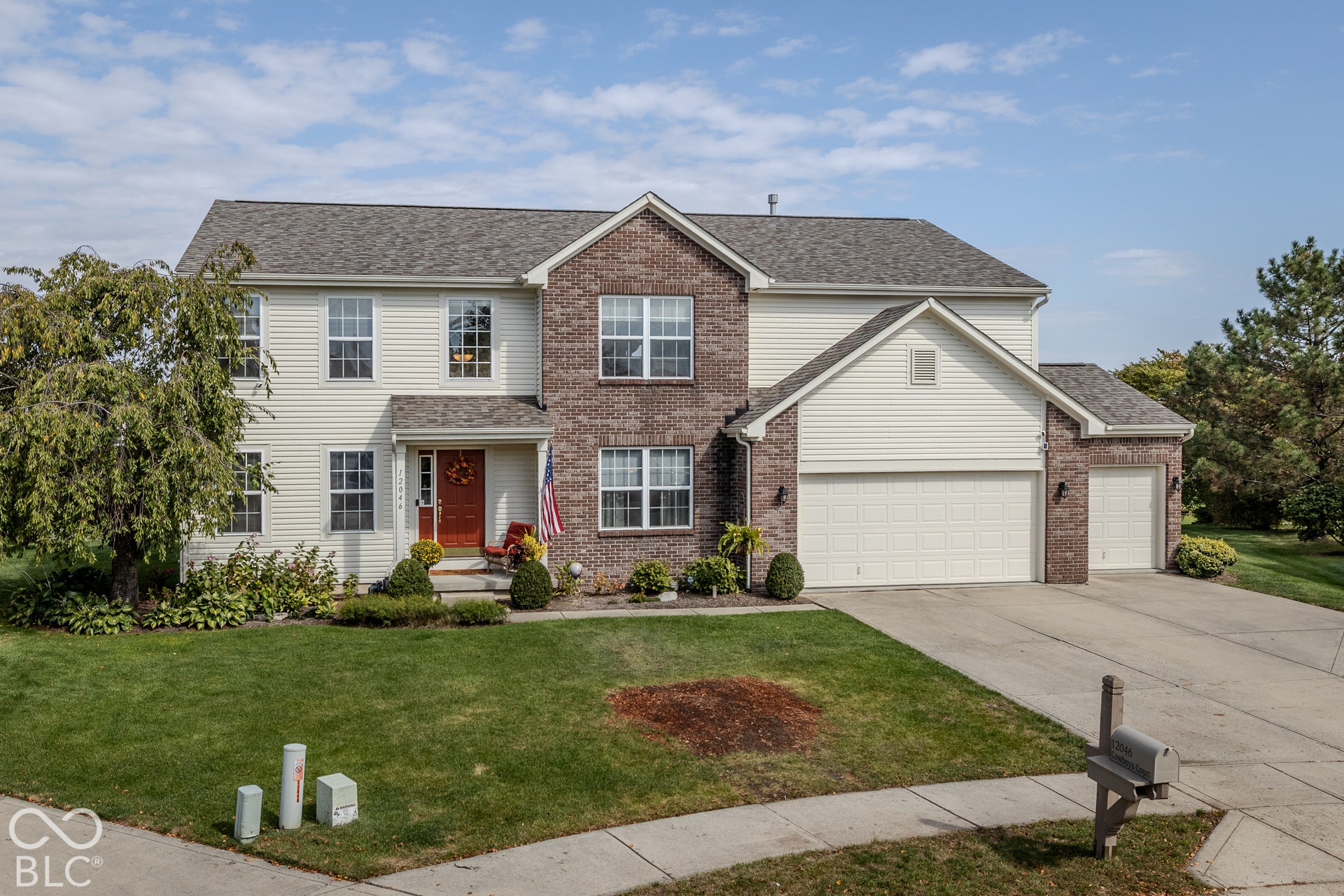 12046 Cowboys, Fishers, IN 46037 The home features a three car garage and lush landscaping.