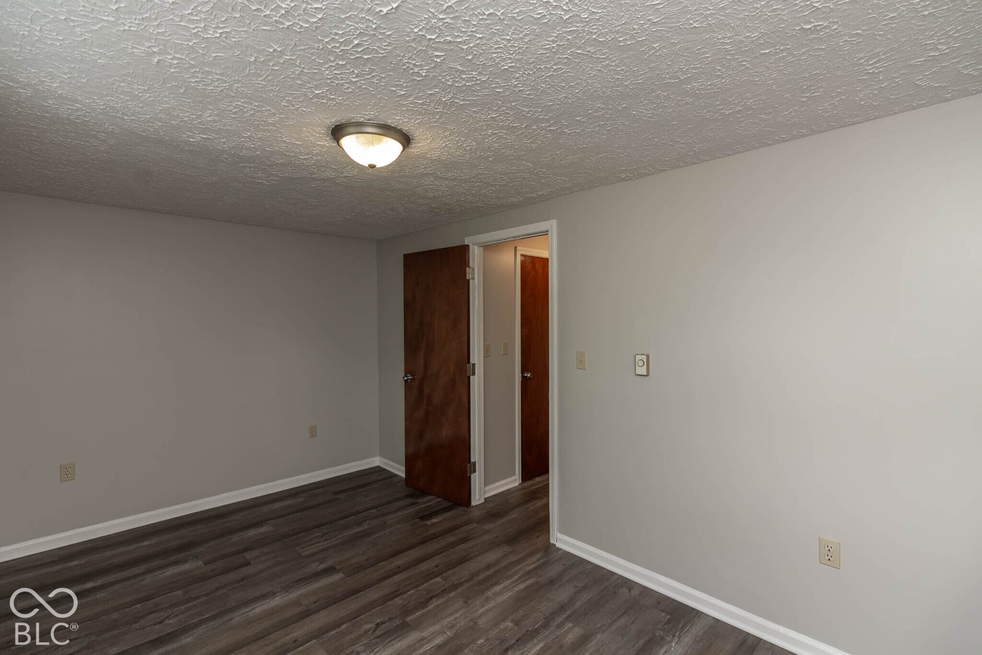 247 Apt. D Kentucky Street, Franklin, IN 46131 Wood-finish flooring, light gray wall paint, and a semi-flush ceiling light fixture