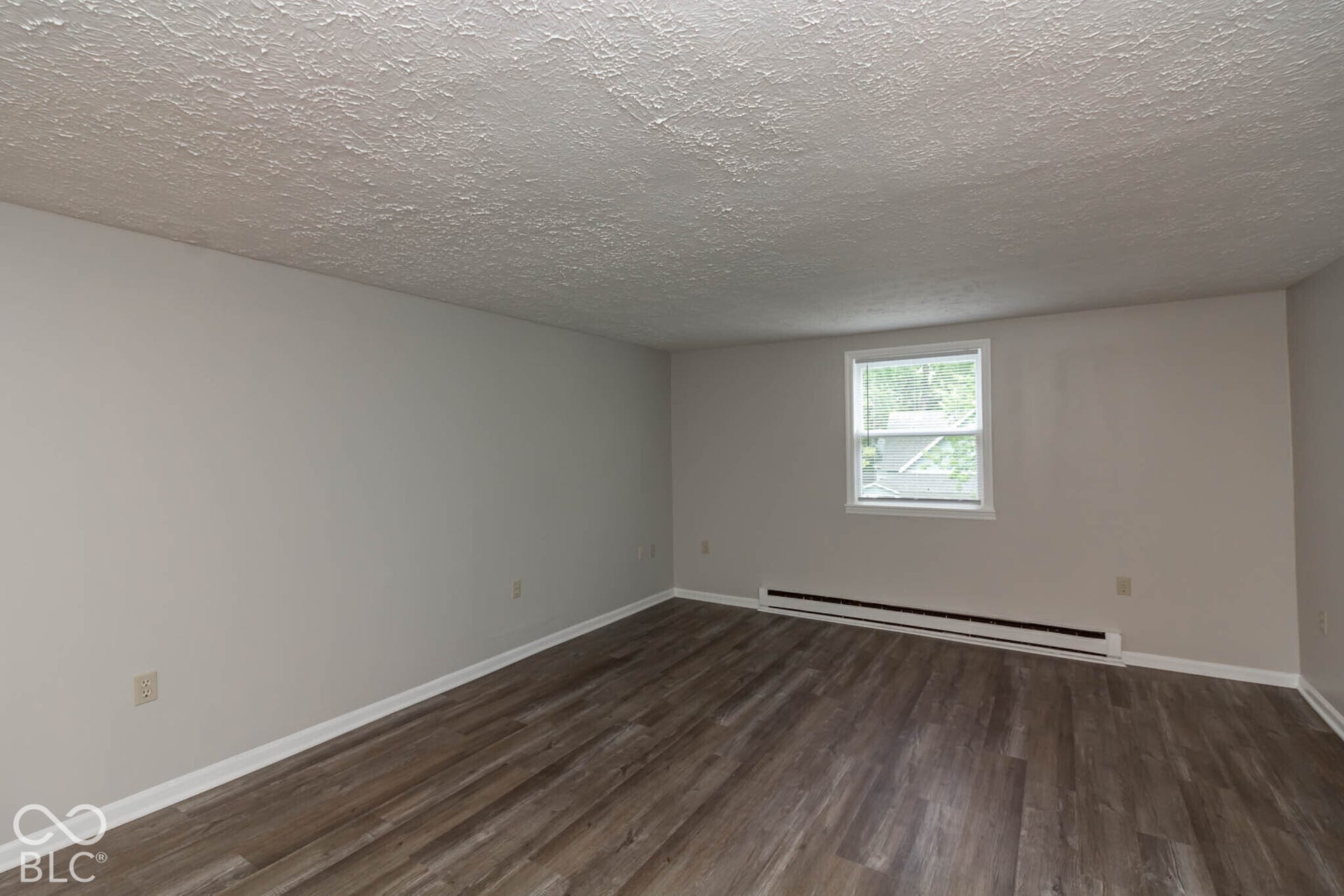 247 Apt. D Kentucky Street, Franklin, IN 46131 Wood-finish flooring, white walls, and a single window with white trim