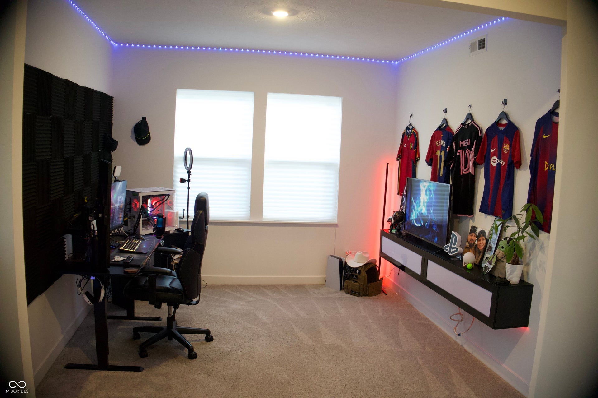 Recessed lighting illuminates neutral carpeting and white walls