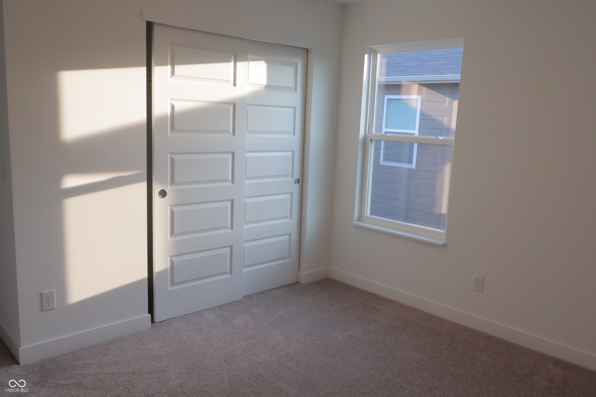Neutral-toned carpeting complements white trim and walls