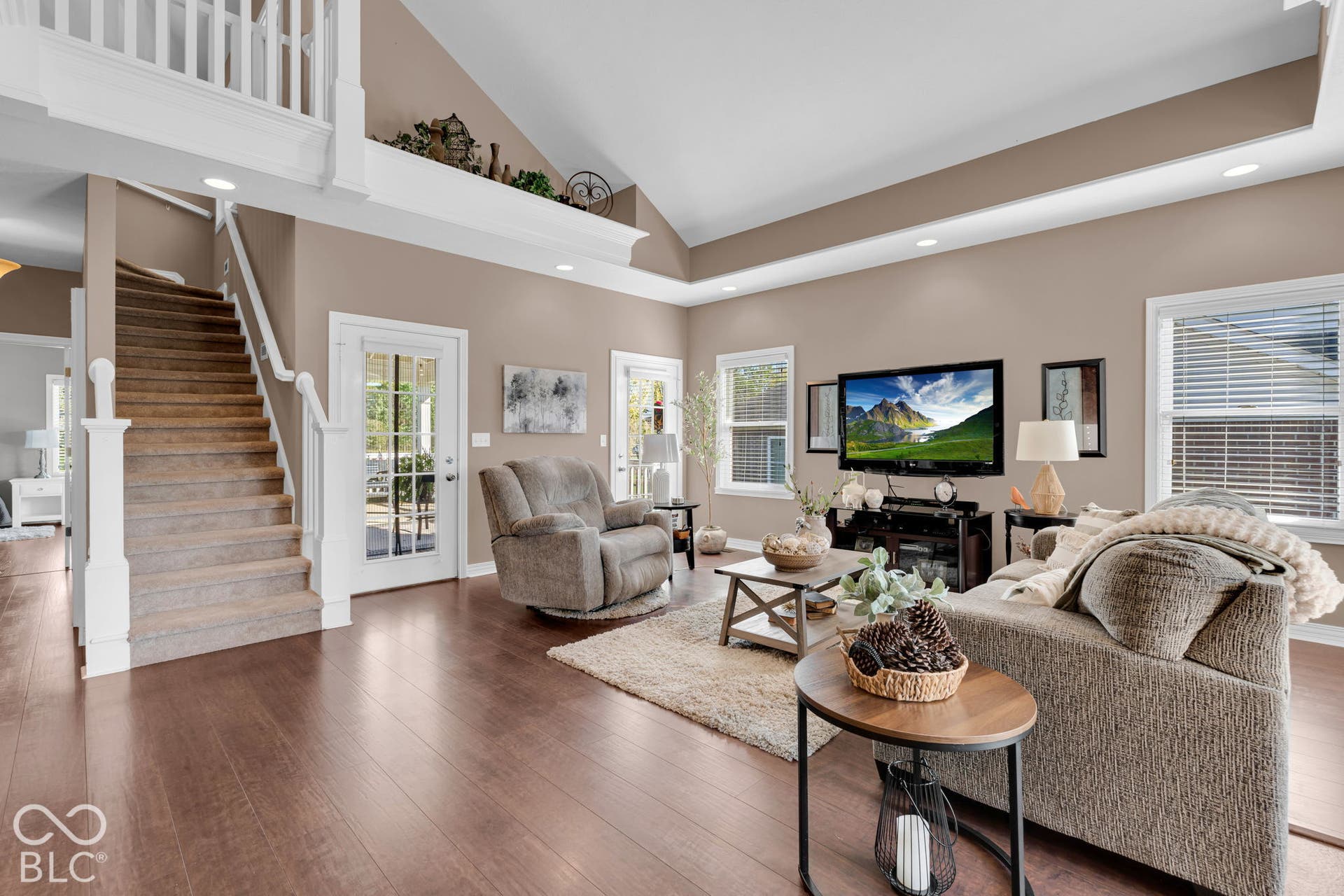 Virtually Altered - Living room with door access to covered patio. Image on T.V. virtually added.