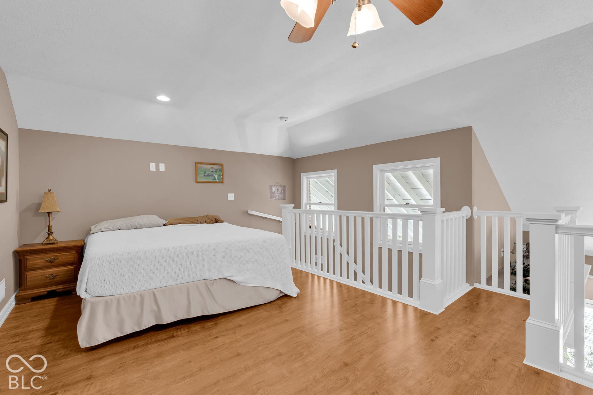 Loft space with carpeted stairs.