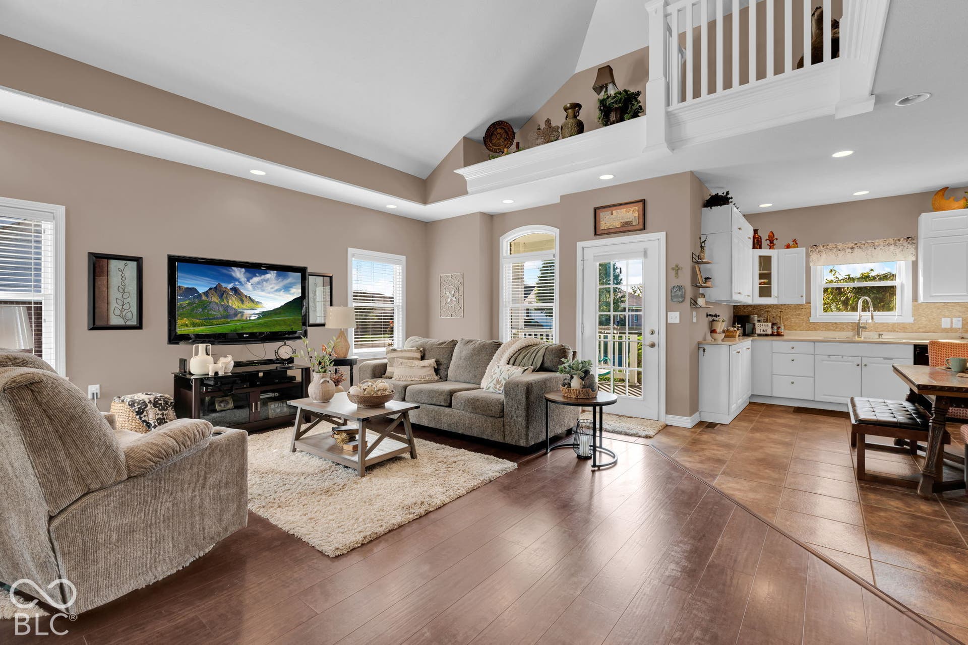 Virtually Altered - Living room with front door visible. Image on T.V. virtually added.