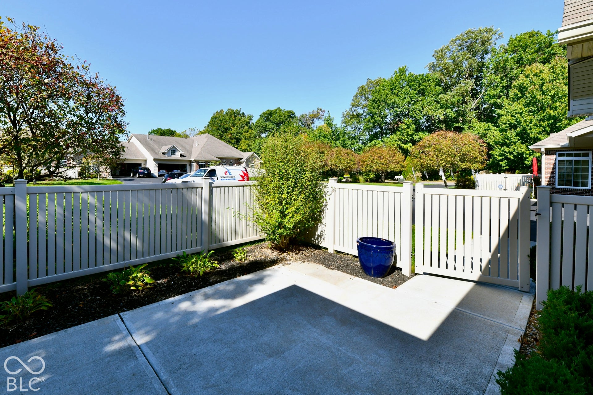 6673 Avila Way, Fishers, IN 46038 Private patio area featuring concrete paving, a white picket fence, and a gate