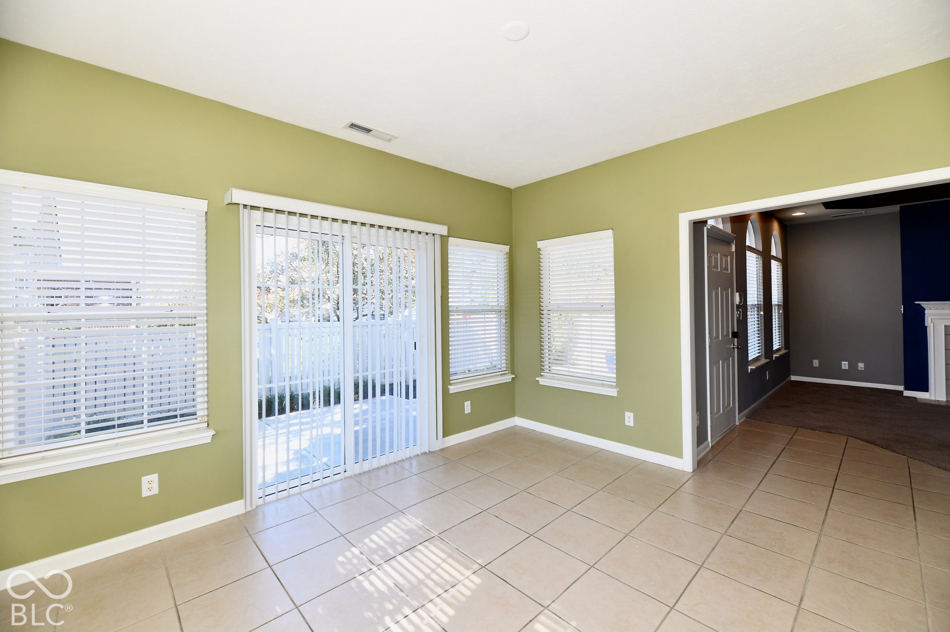 6673 Avila Way, Fishers, IN 46038 Tile flooring, multiple windows with blinds, sliding glass door, recessed lighting, and a wide entryway
