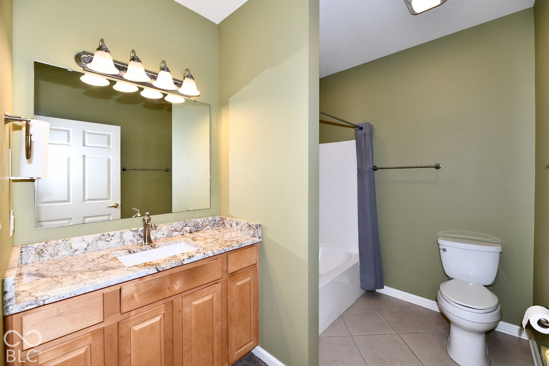 6673 Avila Way, Fishers, IN 46038 Bathroom featuring a vanity with wood cabinetry, integrated sink, and a speckled countertop
