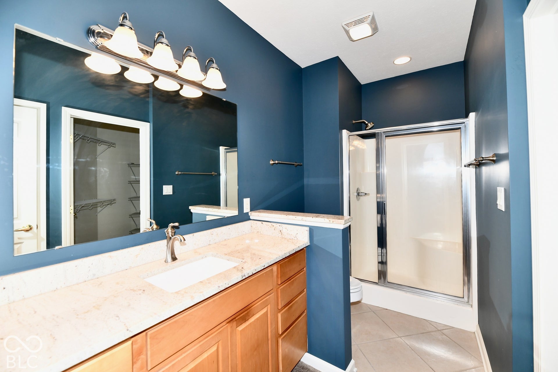 6673 Avila Way, Fishers, IN 46038 Wood-finish vanity with an integrated rectangular sink and light-toned countertop