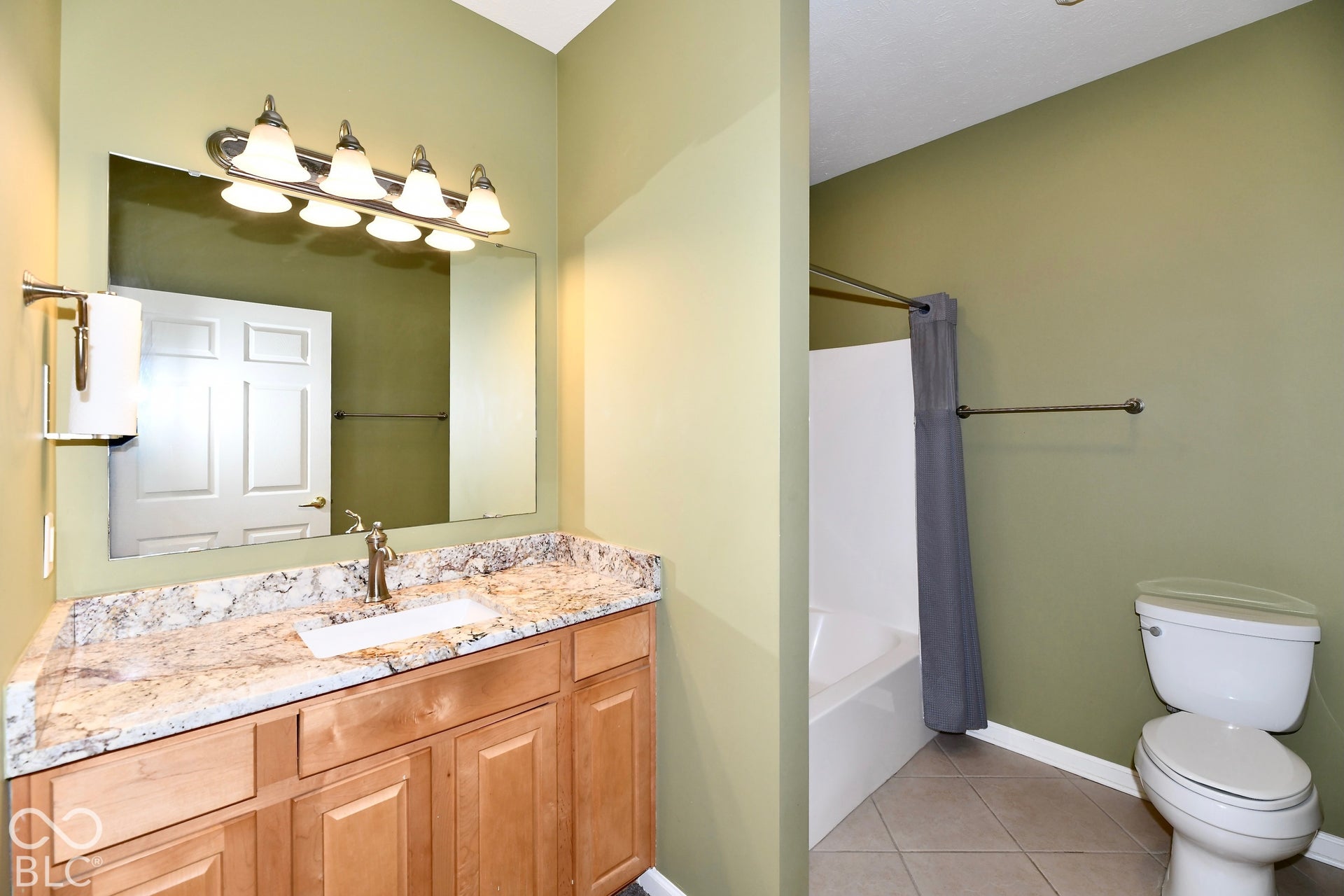 6673 Avila Way, Fishers, IN 46038 Vanity with a rectangular undermount sink, brushed nickel faucet, and a stone countertop