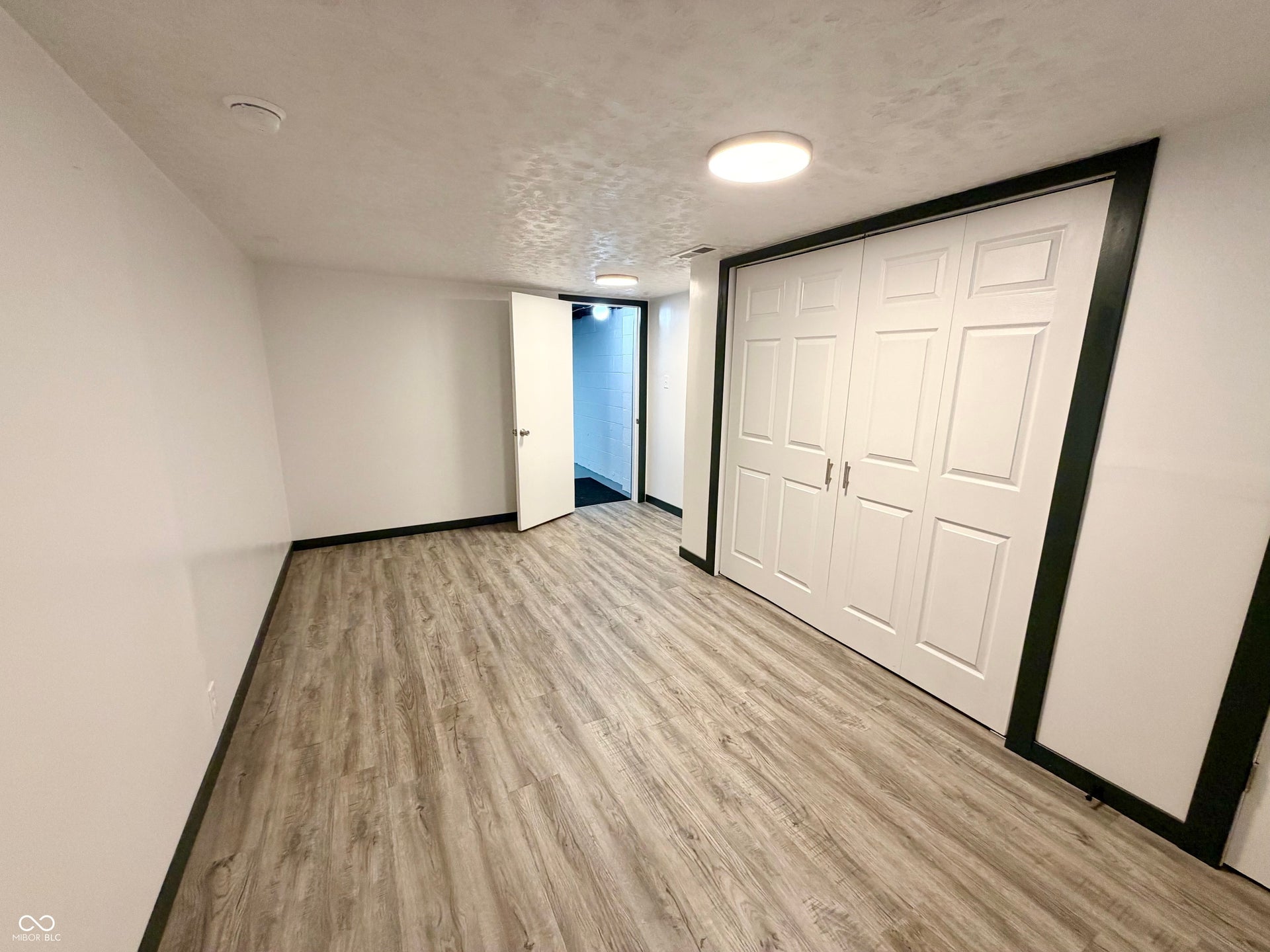 6314 N Keystone Avenue, Indianapolis, IN 46220 Room featuring wood-finish flooring and white walls