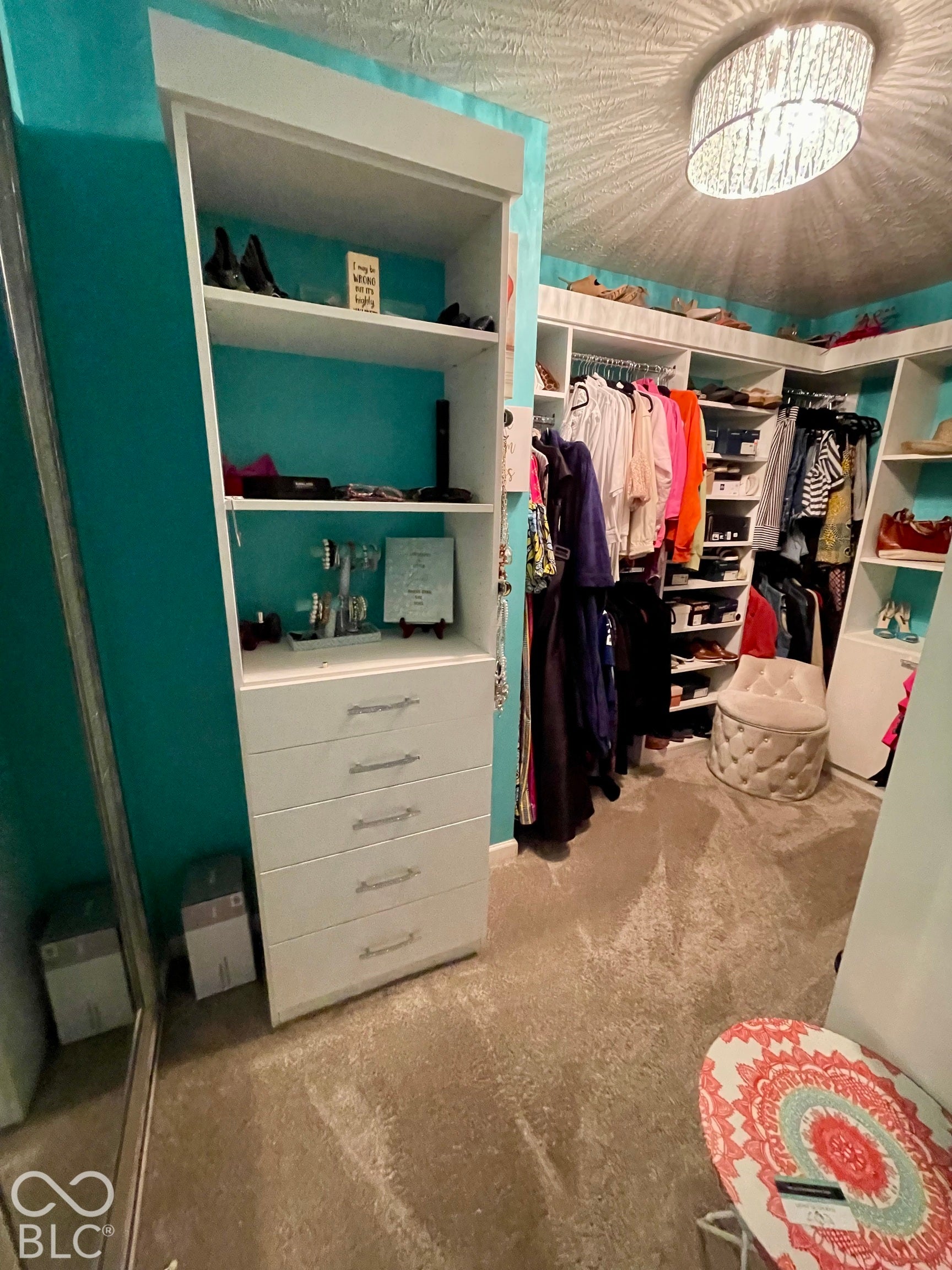 Custom closet system featuring built-in shelving, hanging storage, and integrated drawers