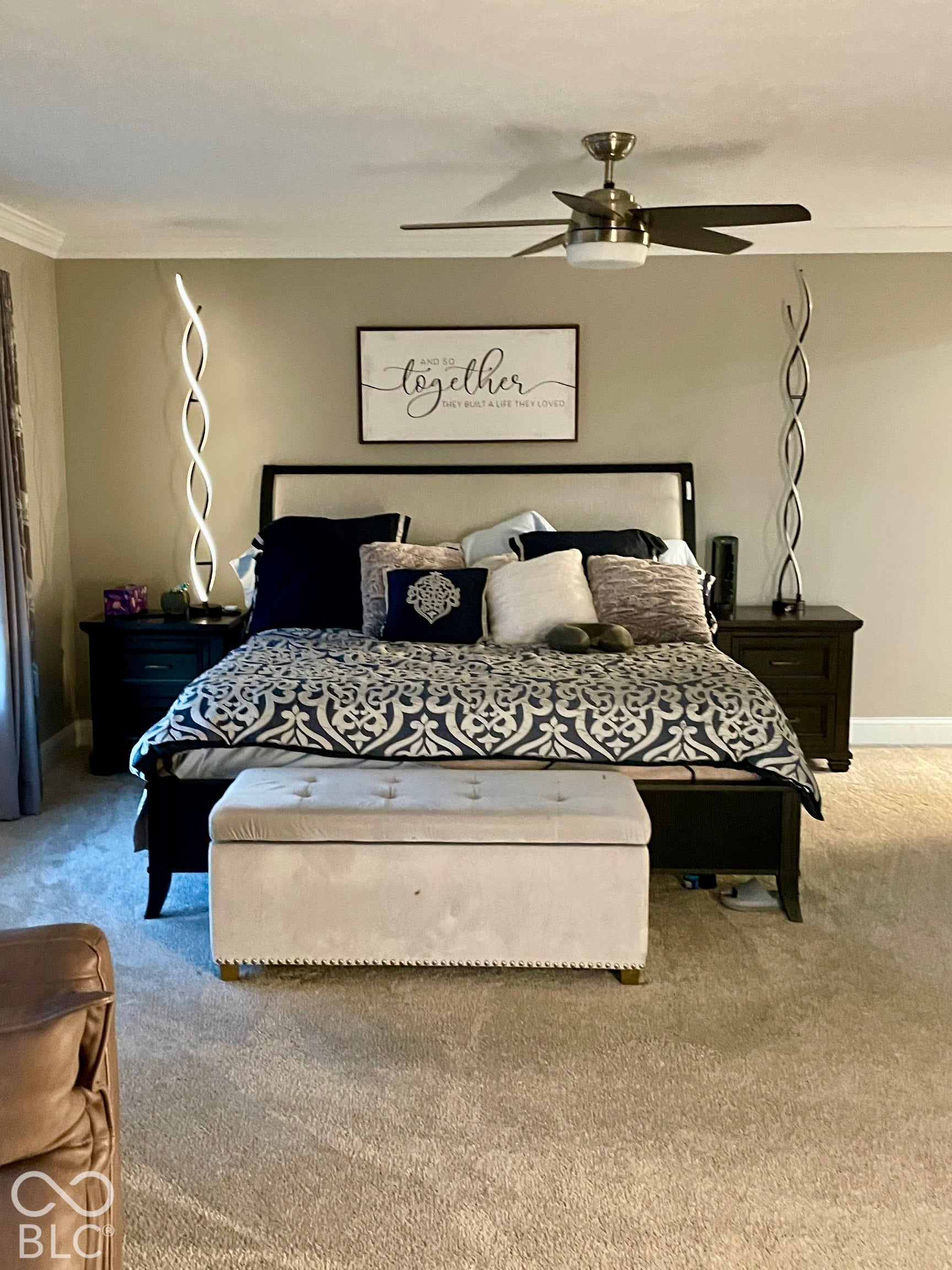 Tray ceiling with crown molding, ceiling fan with integrated lighting, recessed lighting, carpeted flooring, and dark wood-finish nightstands