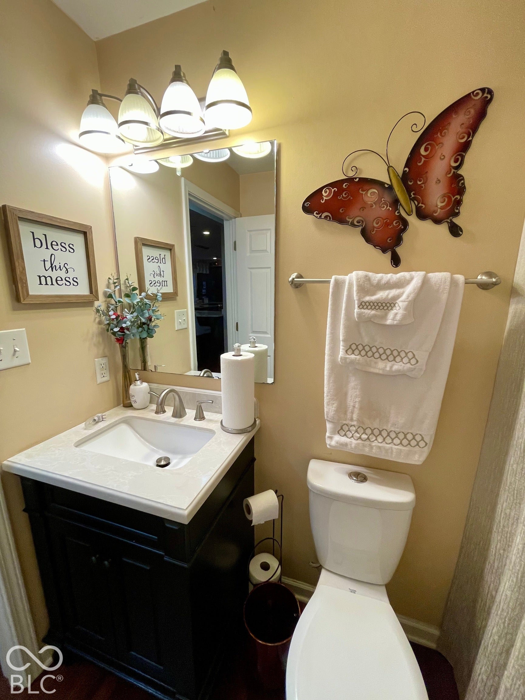 Dark wood-finish vanity with a white countertop and undermount sink