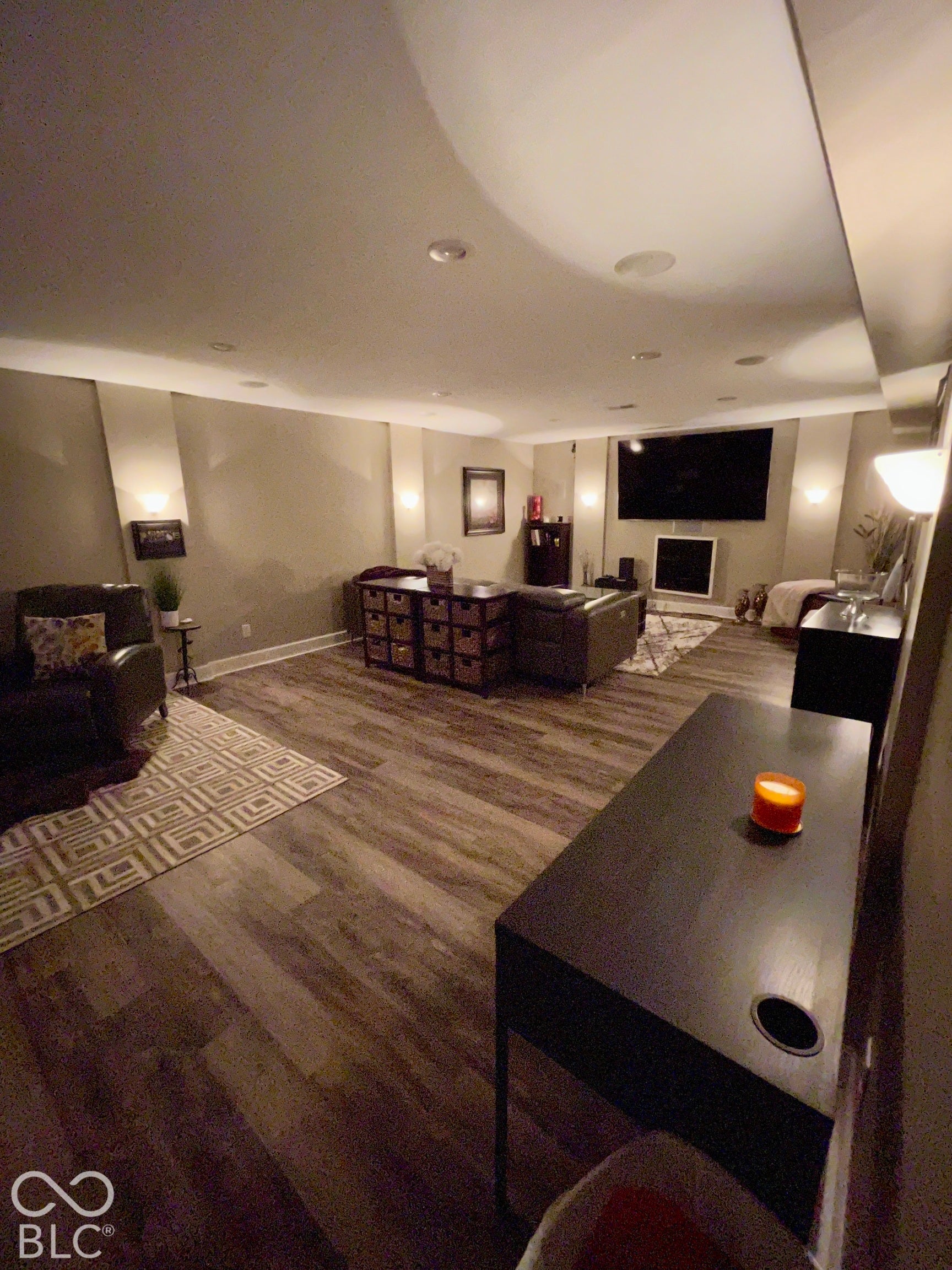 Recessed lighting, wood-finish flooring, and integrated wall sconces