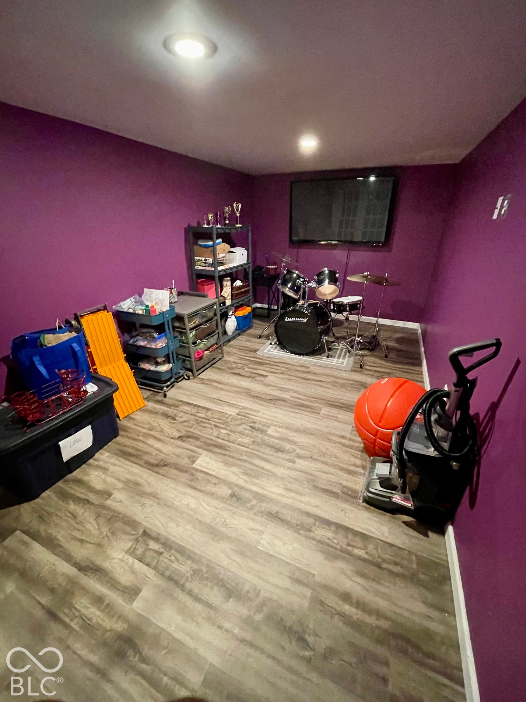 Recessed ceiling lighting, wood-finish flooring, and a wall-mounted display