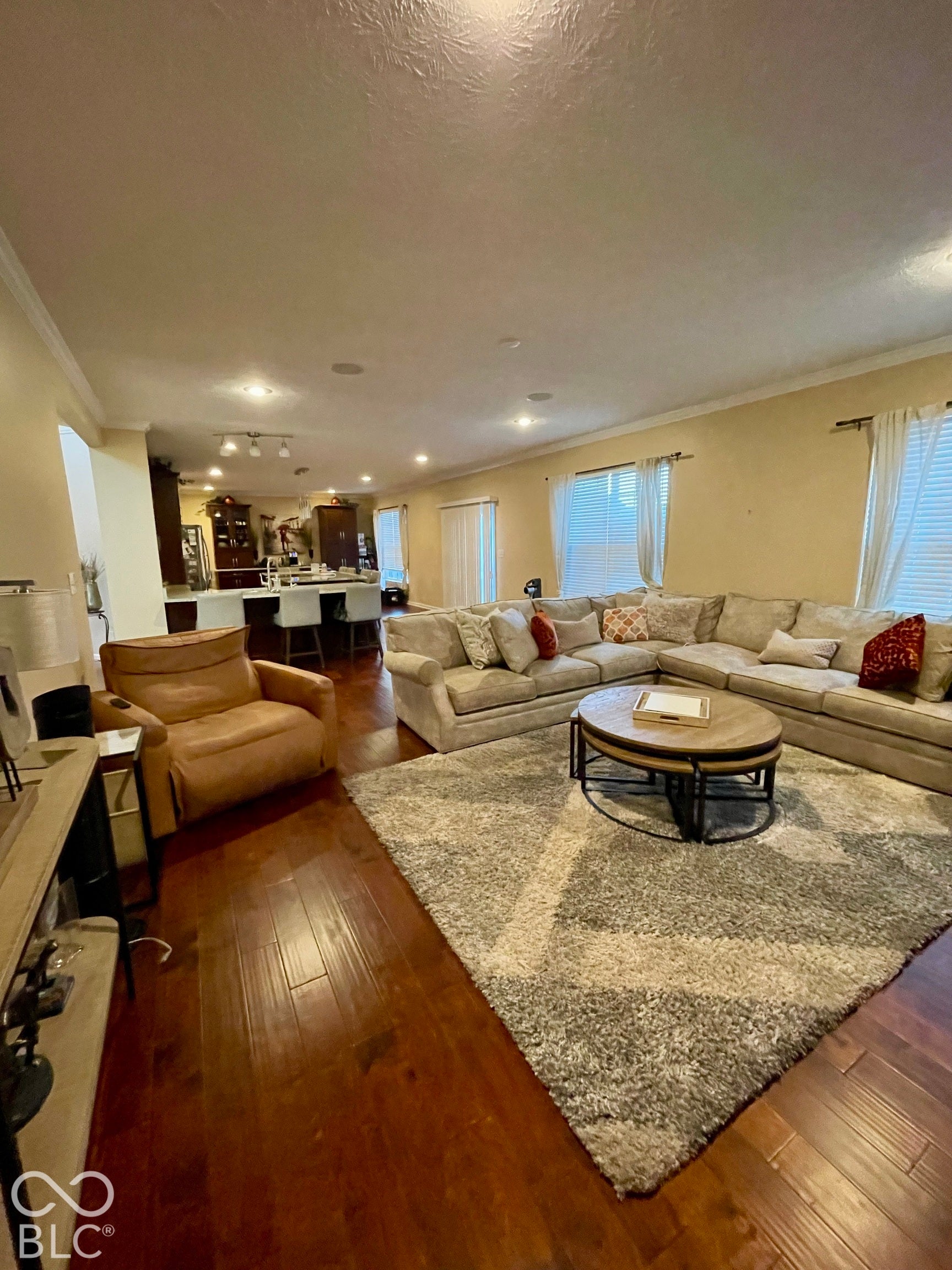 Hardwood-finish flooring, recessed lighting, crown molding, and multiple windows with blinds...All Blinds Stay