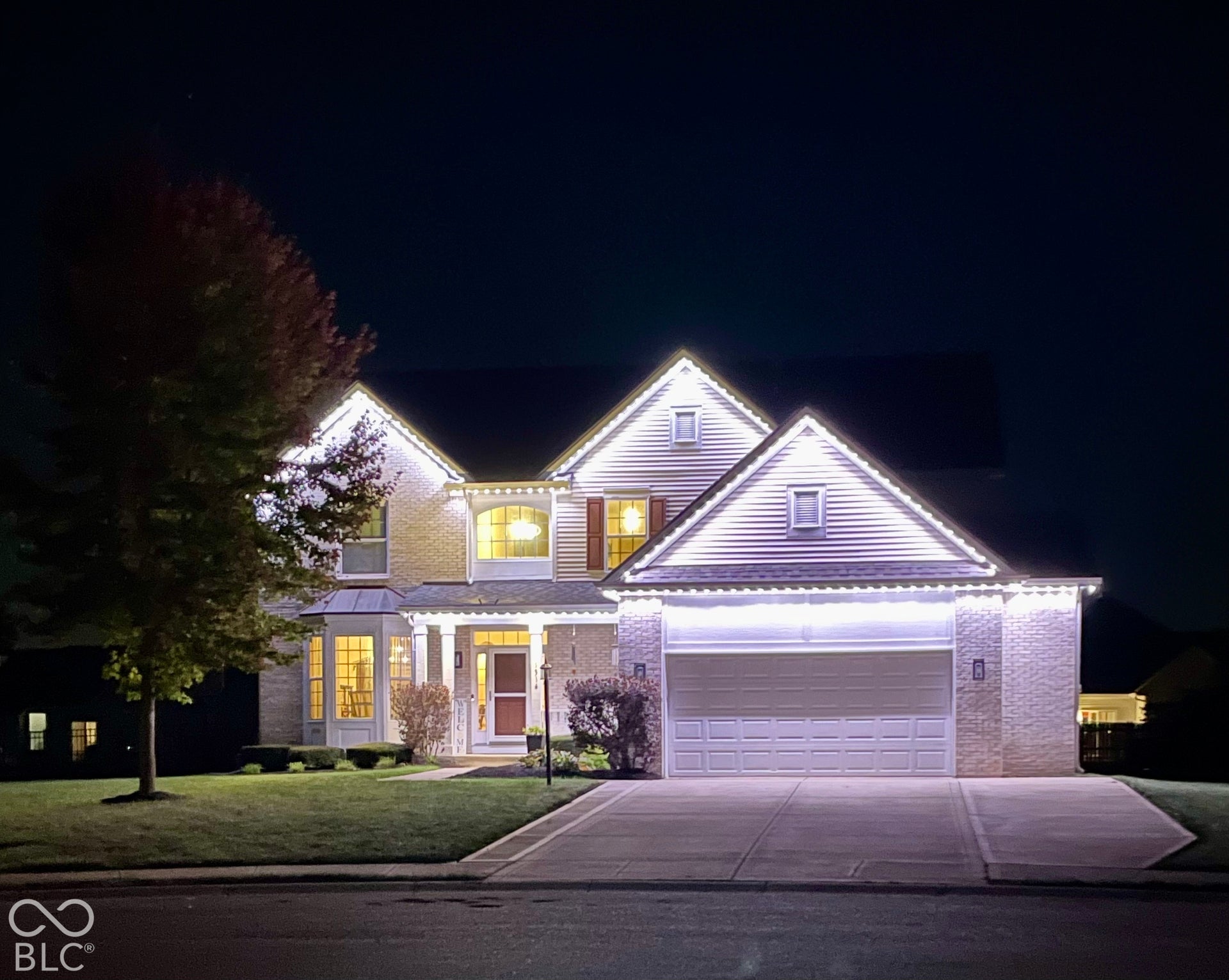 Two-story residence featuring a bay window, a covered front entry, and an attached two-car garage