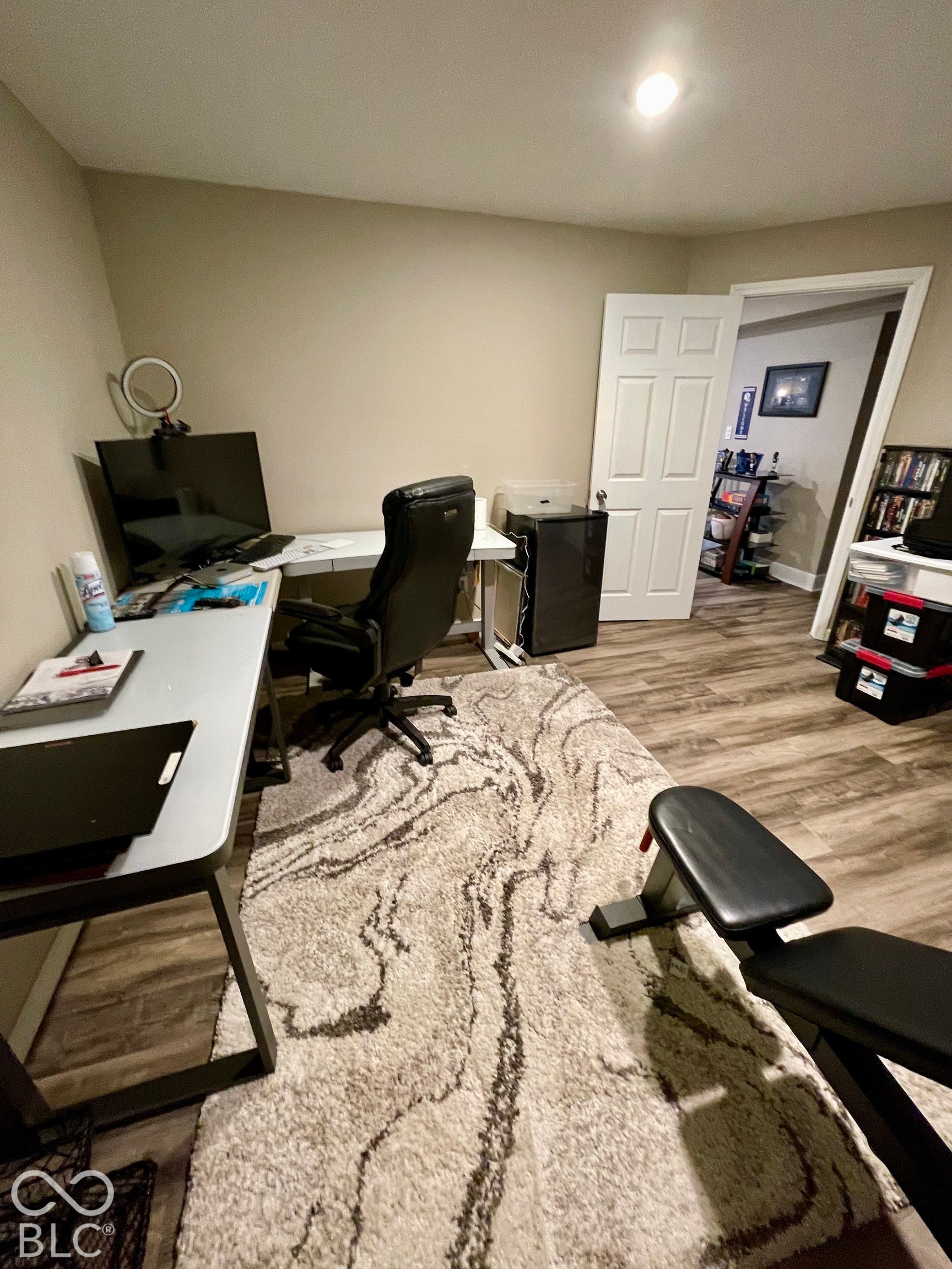 Recessed ceiling lighting, wood-finish flooring, and light-toned walls