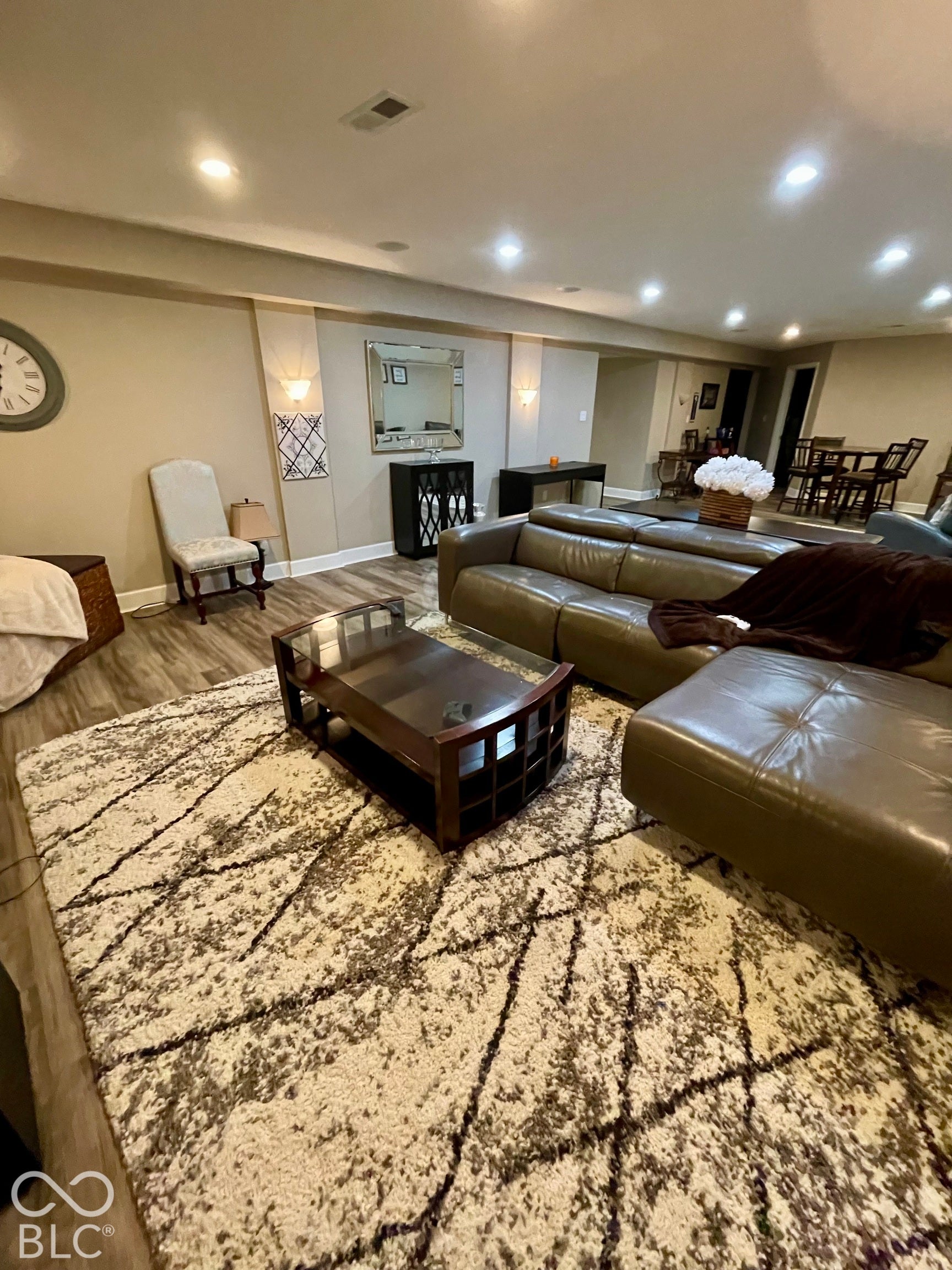 Recessed ceiling lighting, wood-finish flooring, and built-in wall sconces