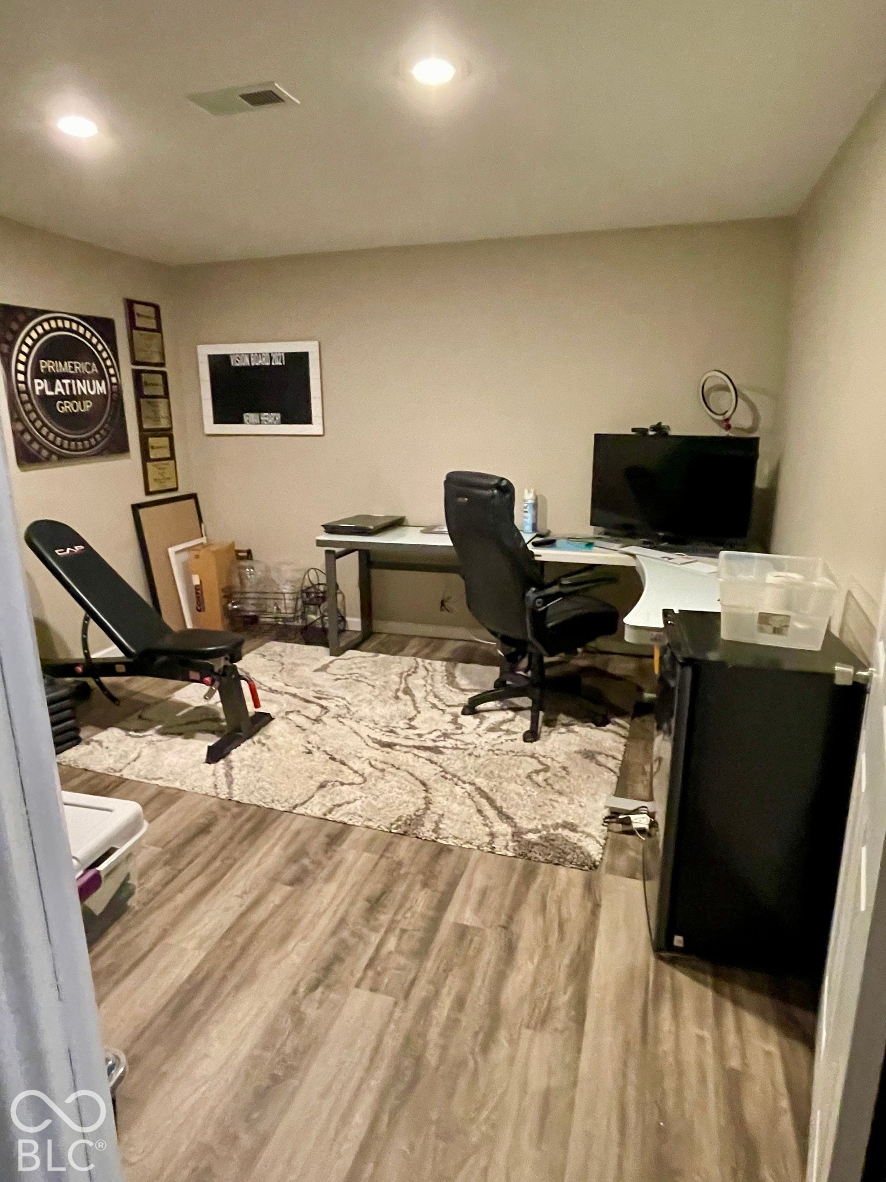 Recessed ceiling lighting, wood-finish flooring, and neutral wall tones