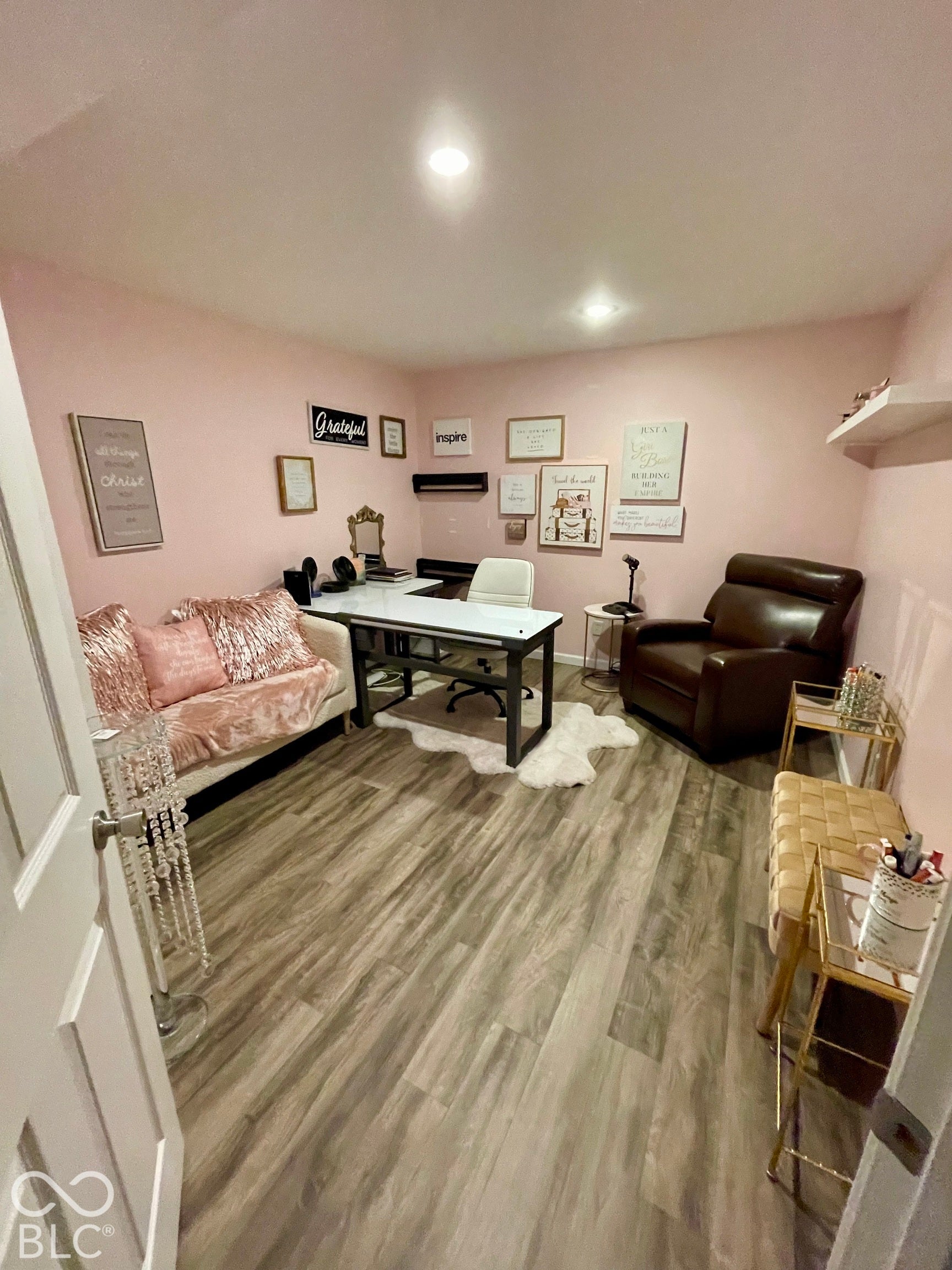 Recessed ceiling lighting, wood-finish flooring, and white walls