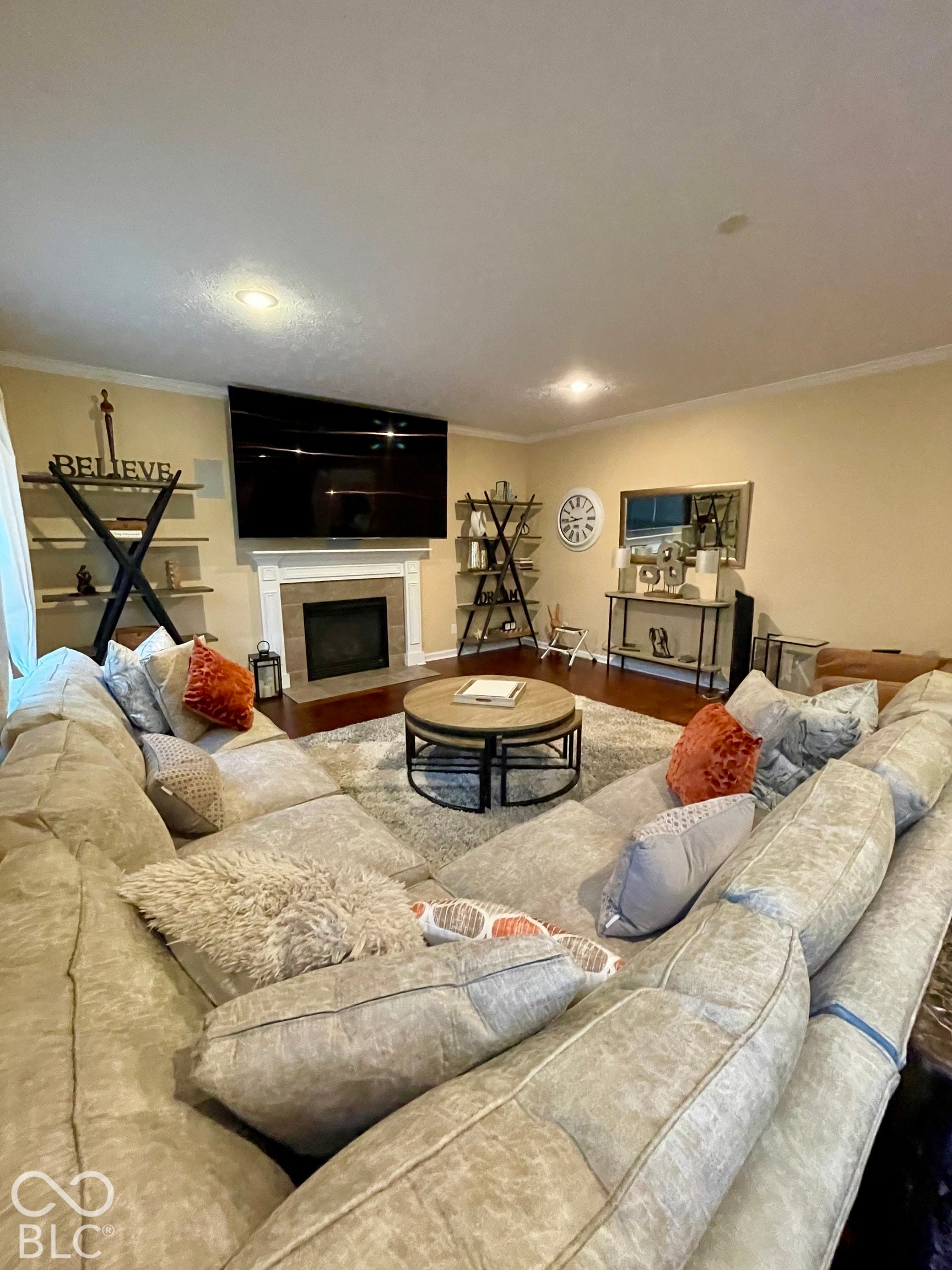 Recessed lighting illuminates the room, featuring a cozy gas fireplace
