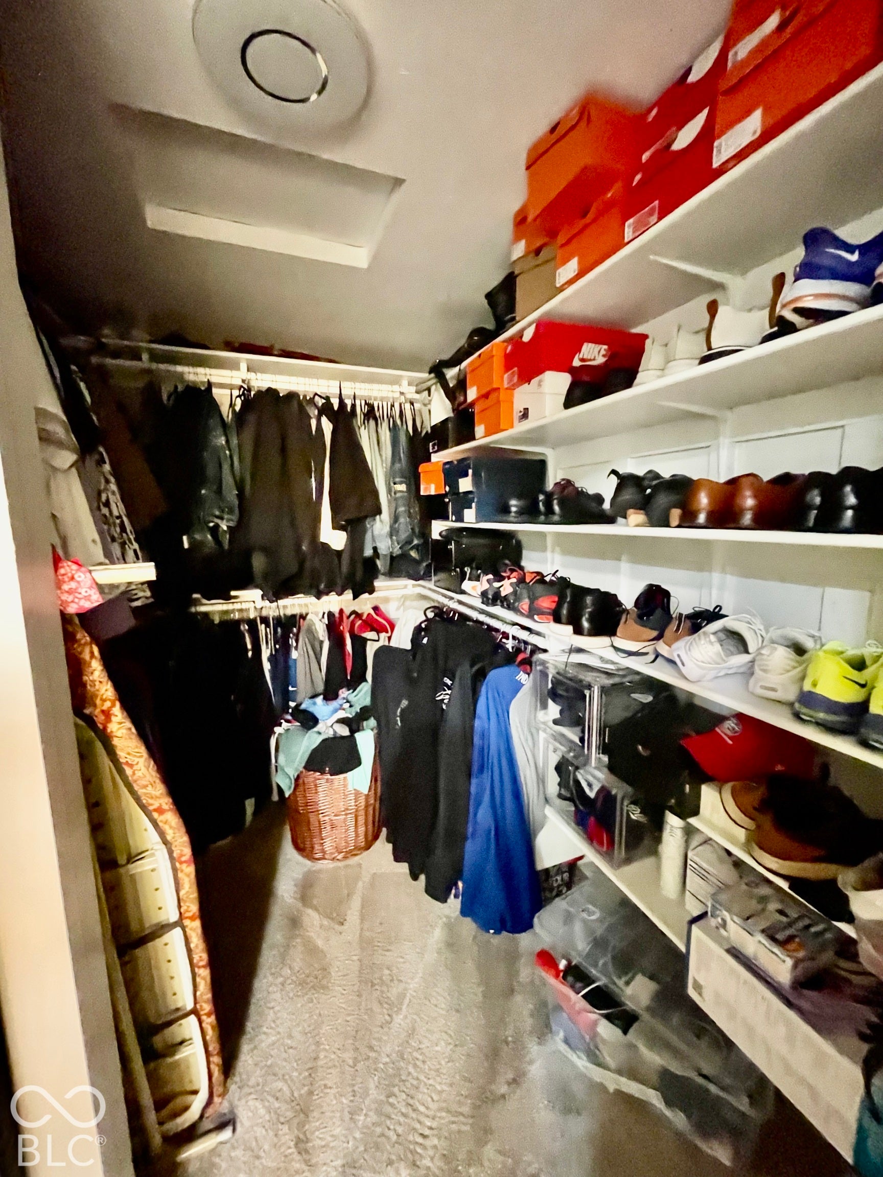 Primary Bedroom "His" walk in closet with shelving