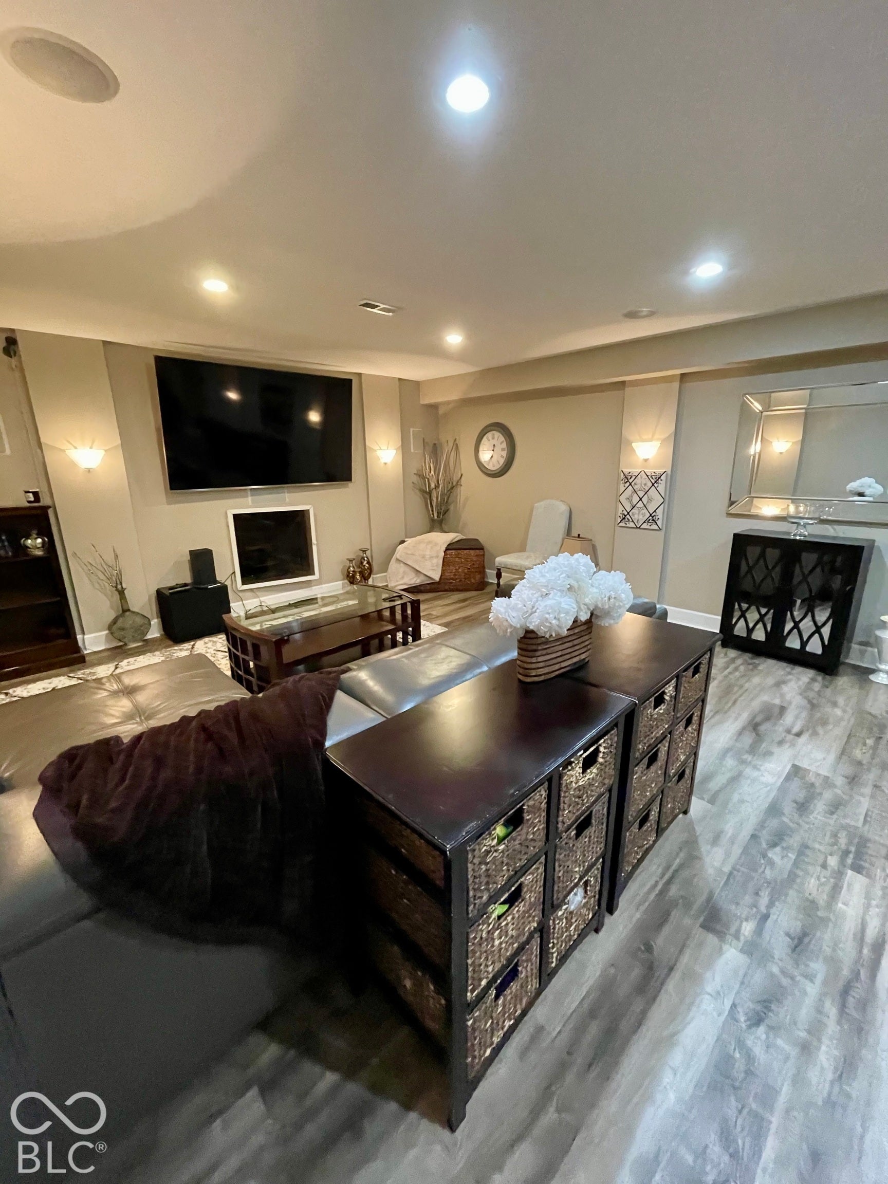 Recessed lighting, wall sconces, wood-finish flooring, and built-in ceiling speakers