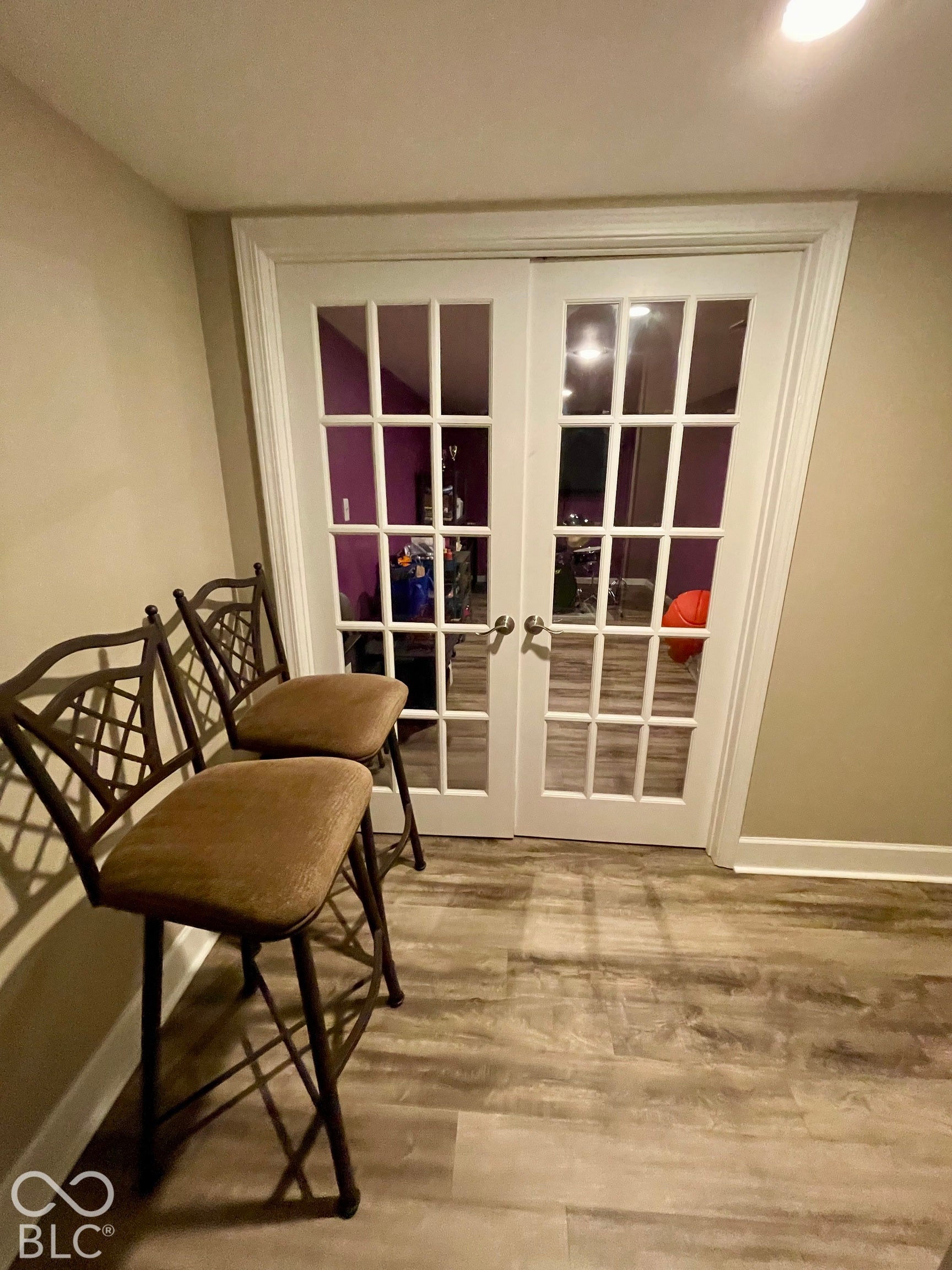 White French doors with multiple lites, light wood-finish flooring, and recessed ceiling lighting