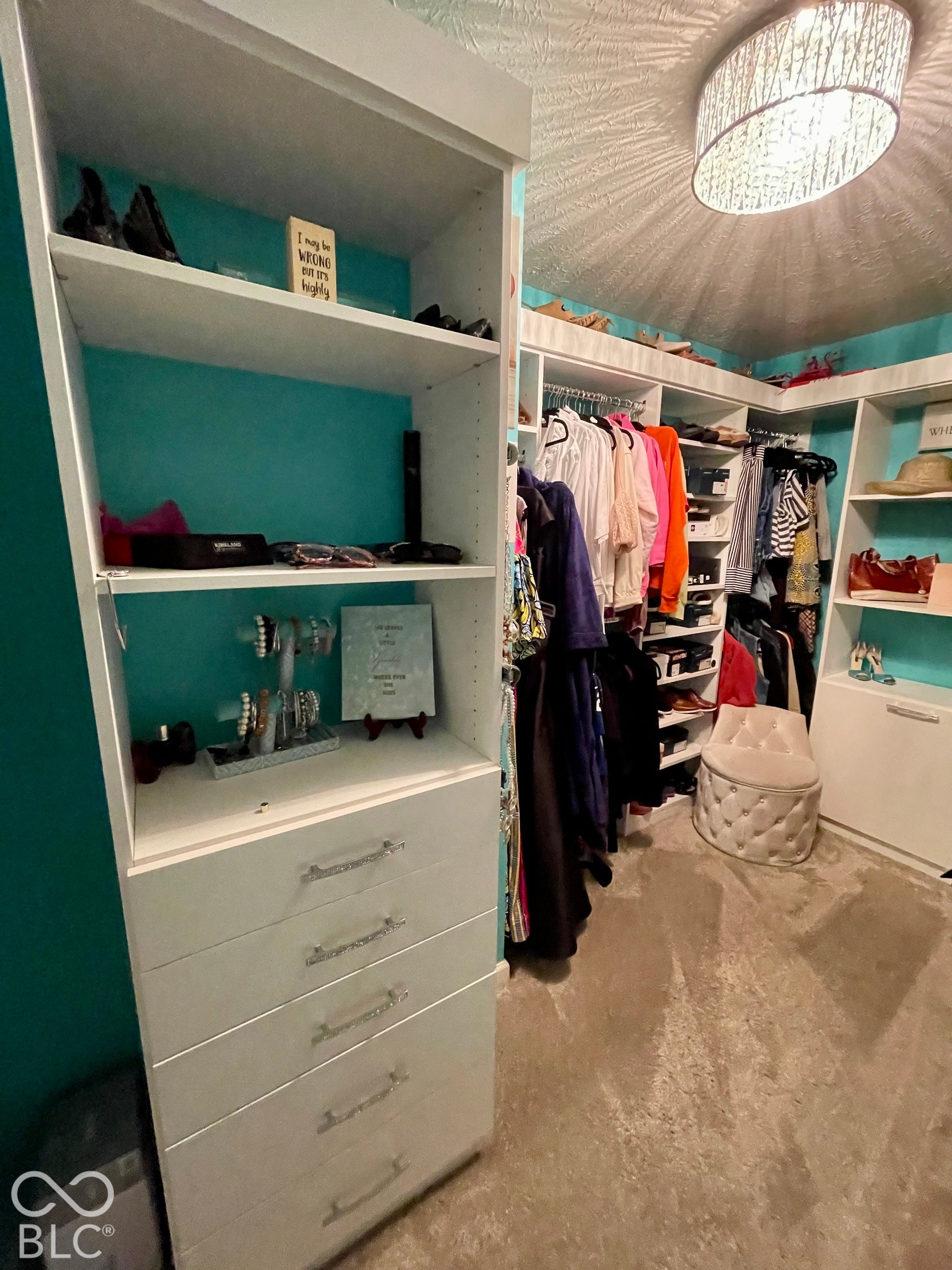 Built-in closet system with shelving, drawers, and hanging rods