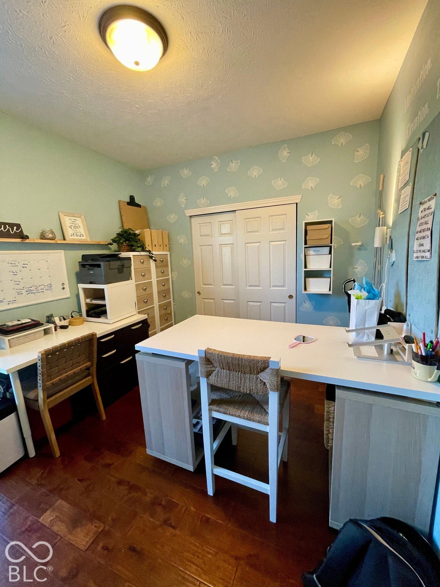 Hardwood-finish flooring, built-in shelving, recessed lighting, and wall-to-wall closet doors