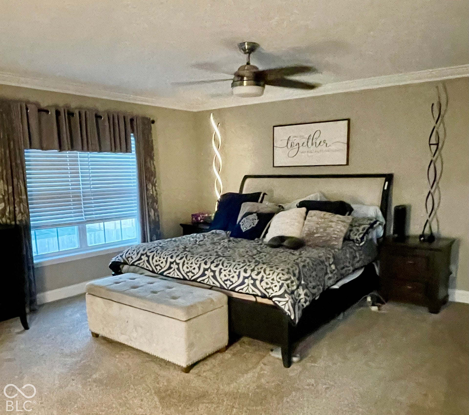 Window with blinds and drapes, ceiling fan with light, and carpeted flooring...All blinds stay
