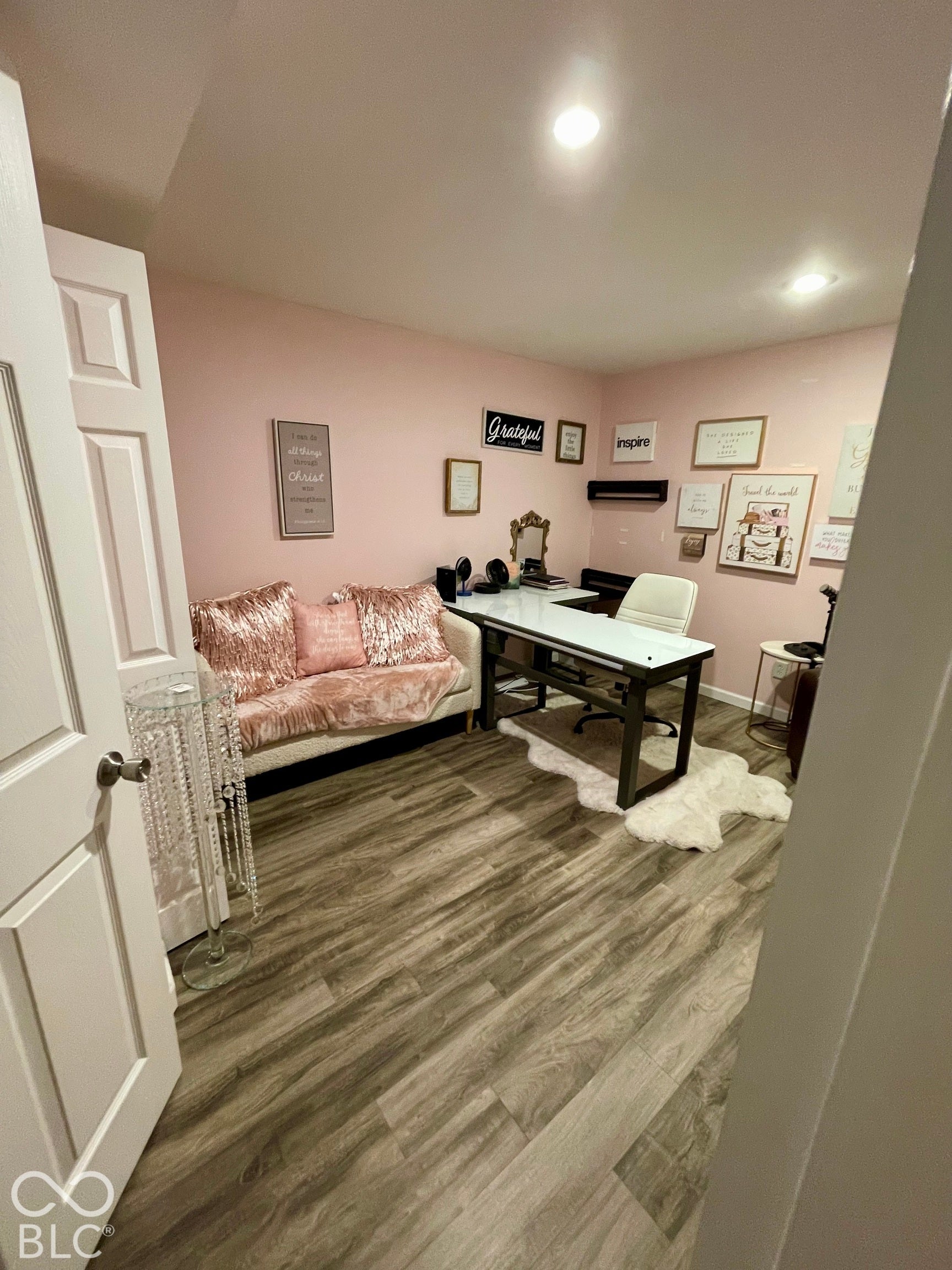 Recessed lighting, wood-finish flooring, and a paneled interior door