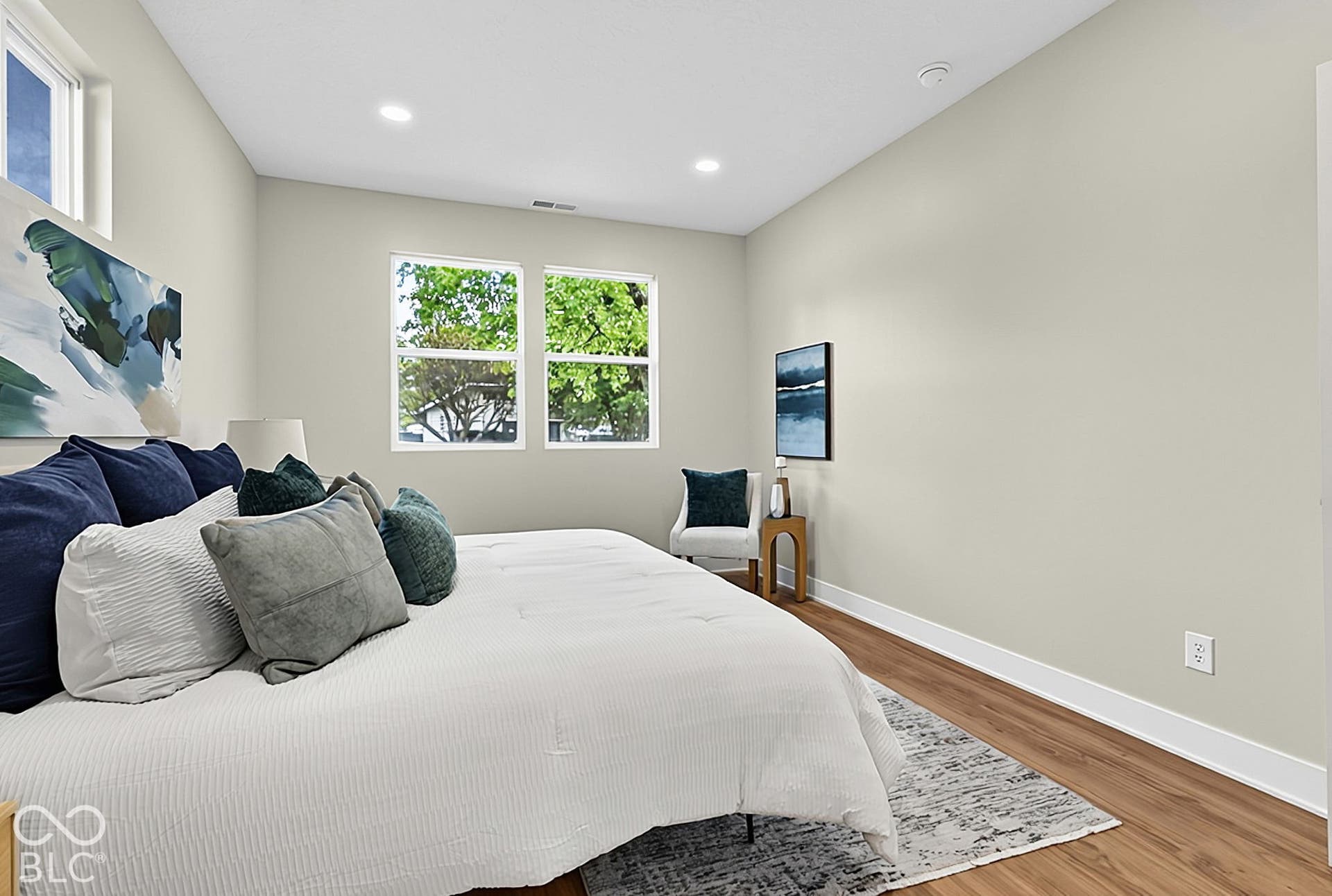 Neutral interior featuring wood-finish flooring, recessed lighting, and expansive double-pane windows