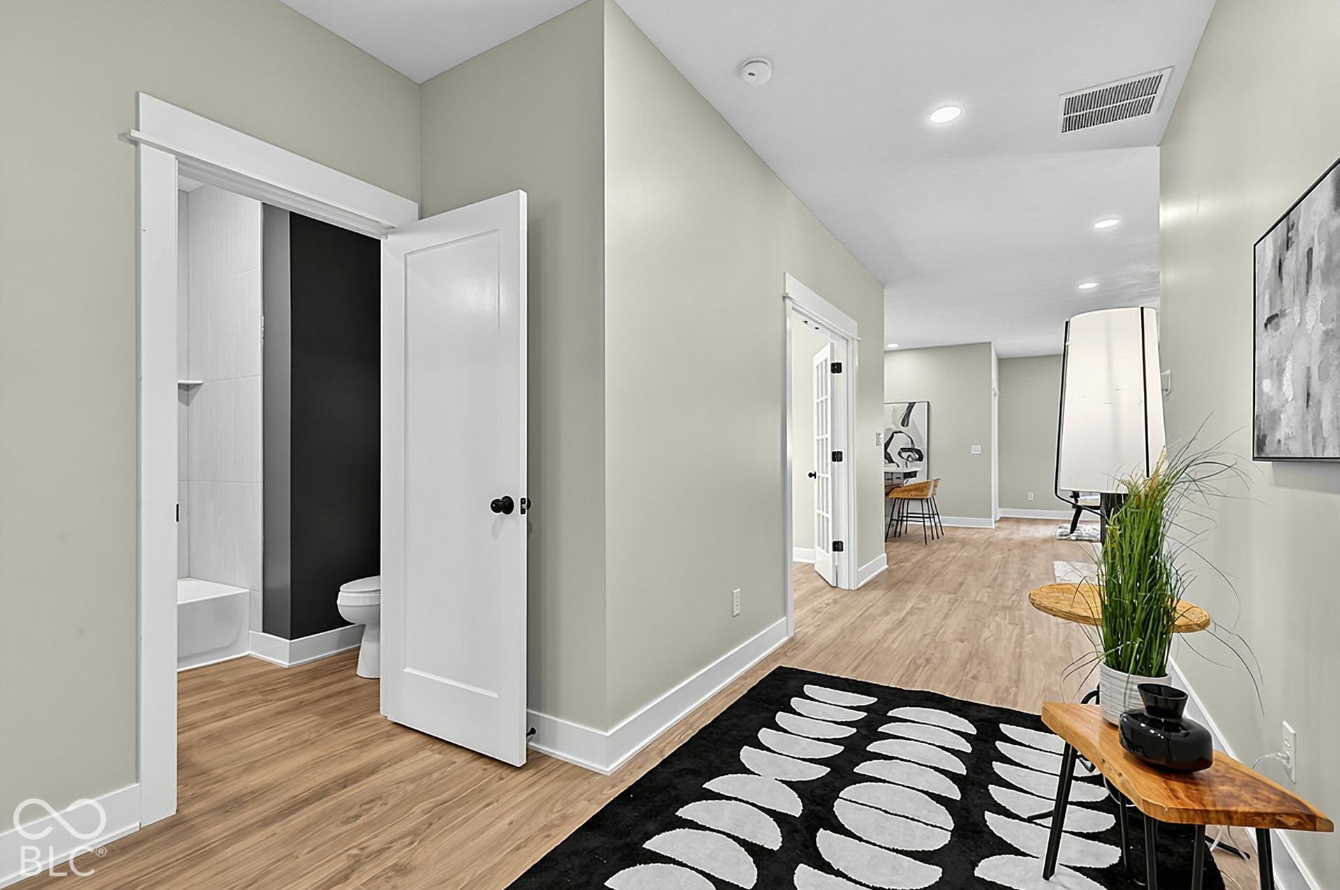 Interior space featuring wood-finish flooring, recessed lighting, and crisp white door trim