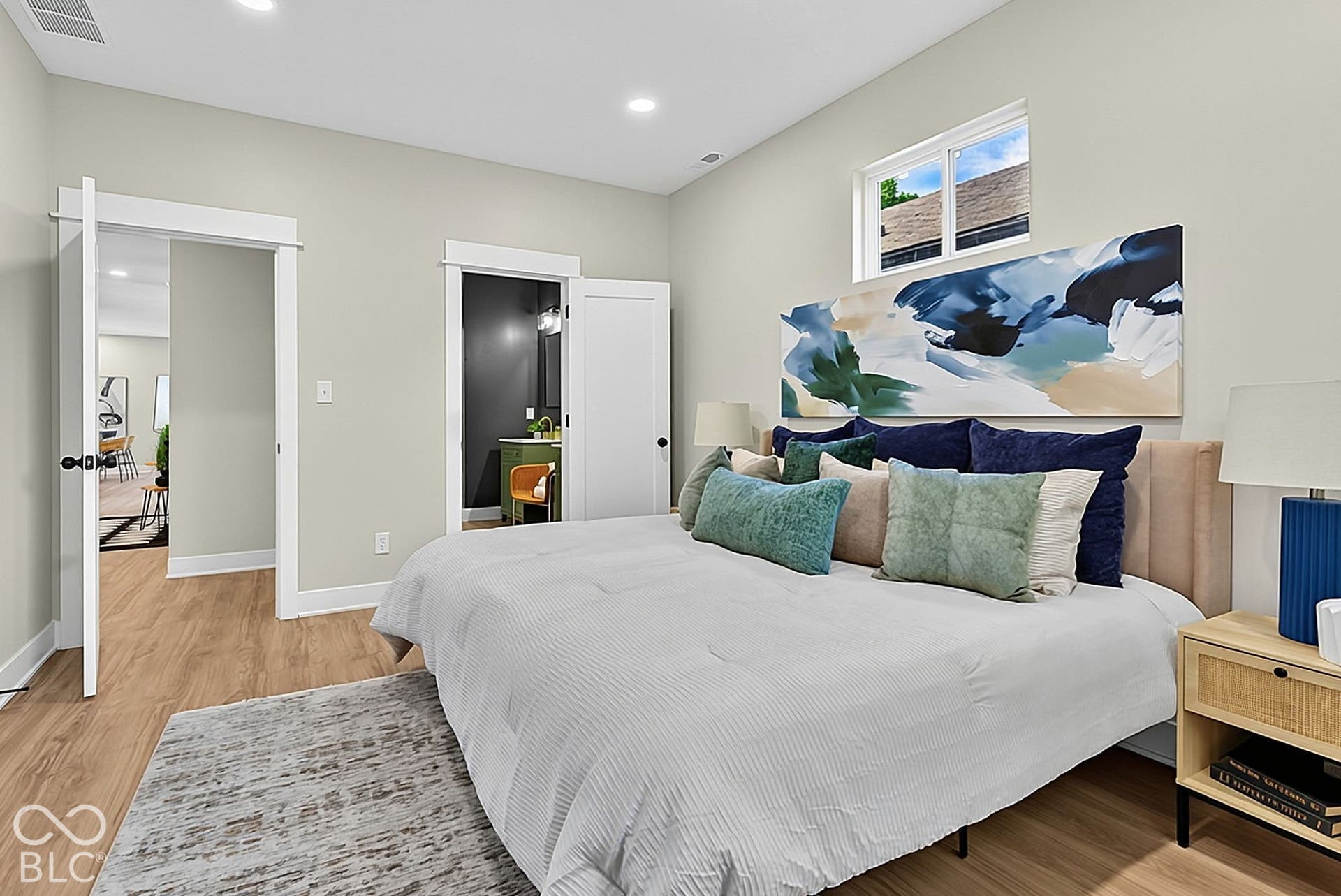 Neutral-toned walls, wood-finish flooring, recessed lighting, and a horizontal sliding window