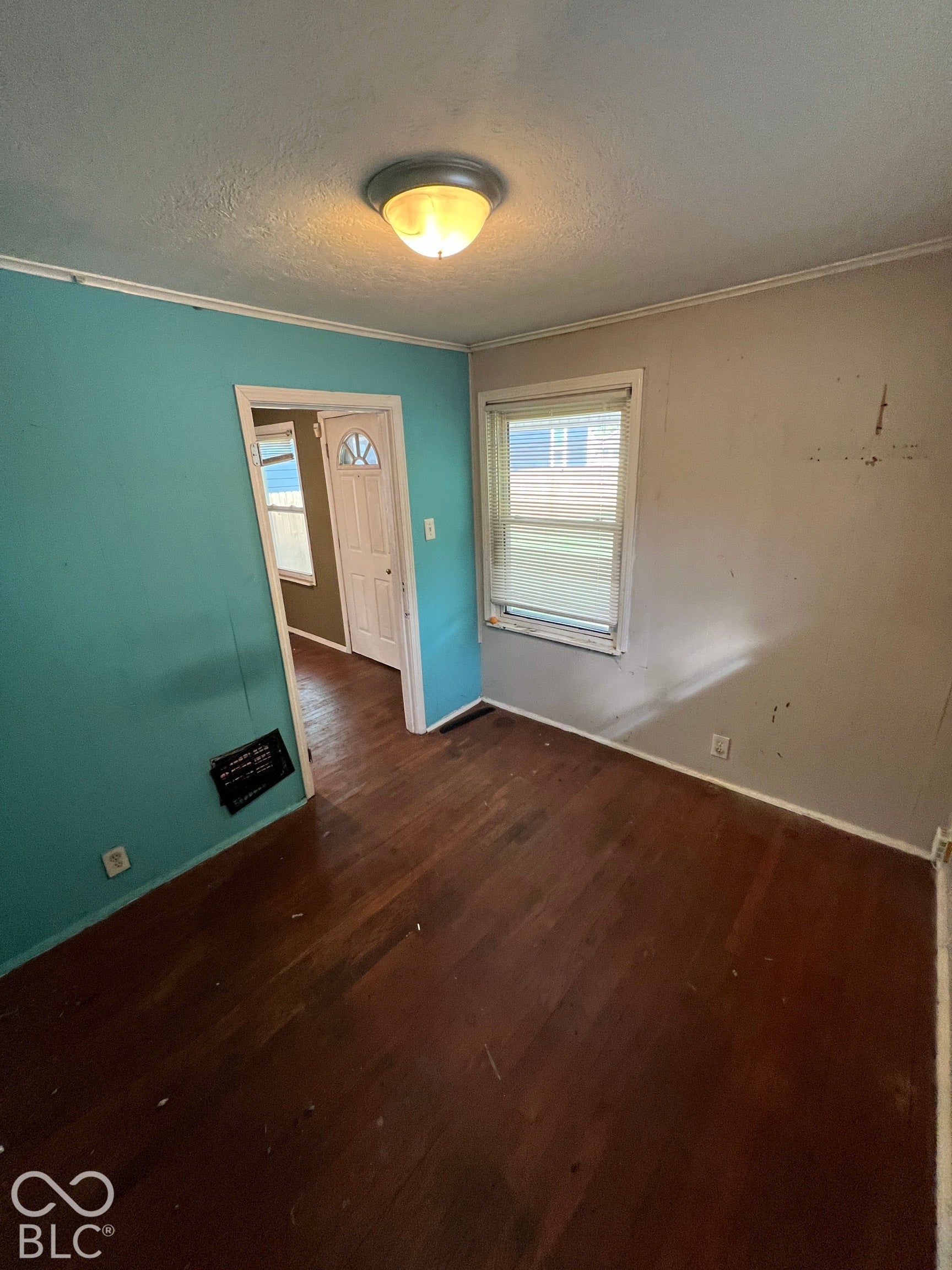 1431 W Pruitt Street, Indianapolis, IN 46208 Wood-finish flooring, overhead dome light fixture, and a window with blinds