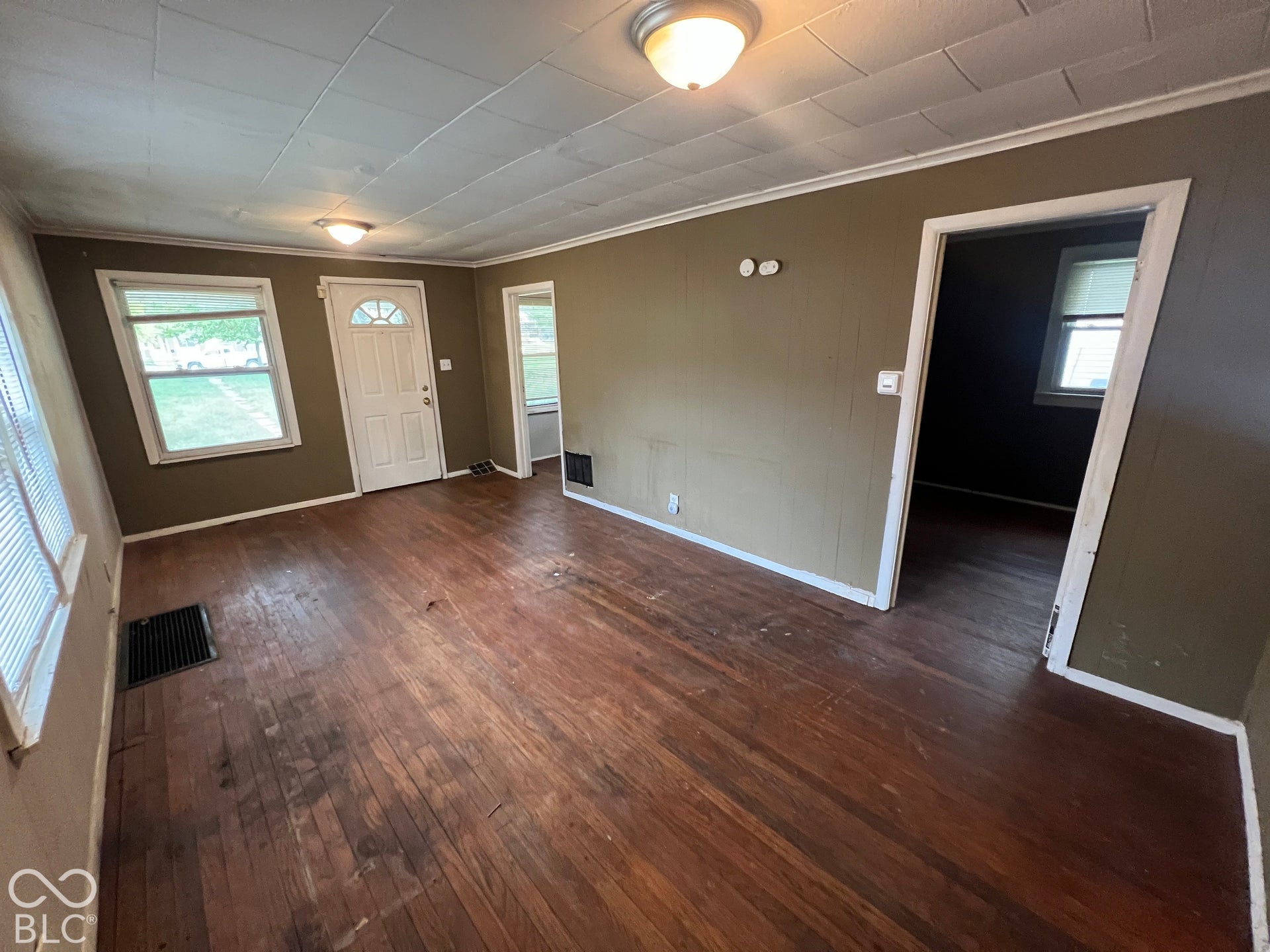 1431 W Pruitt Street, Indianapolis, IN 46208 Wood-finish flooring throughout, multiple windows with natural light, and a paneled ceiling