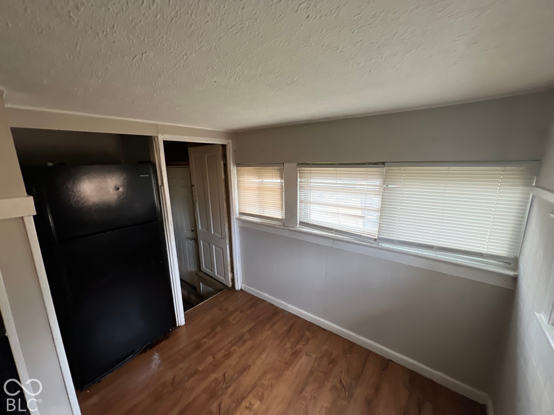 1431 W Pruitt Street, Indianapolis, IN 46208 Wood-finish flooring with multiple windows and a built-in refrigerator