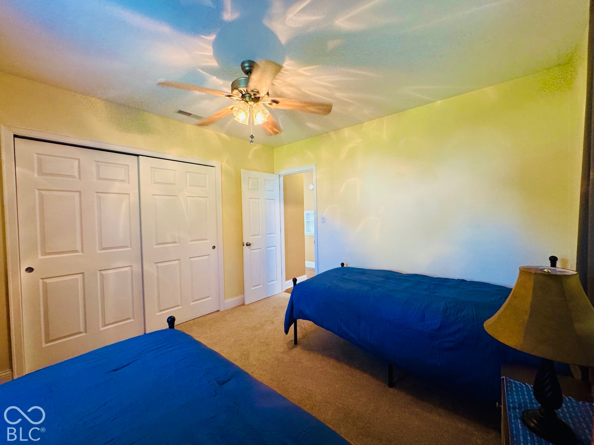 Recessed lighting with a ceiling fan, carpeted flooring, and paneled closet doors