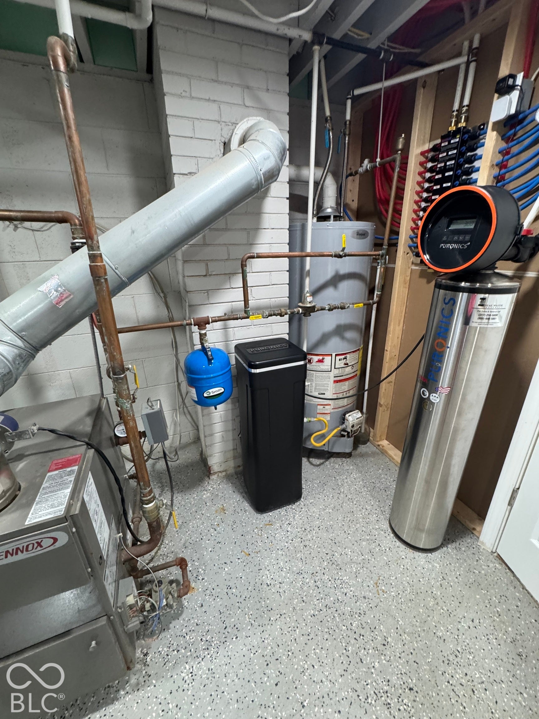 Water heater with associated plumbing, water softener system, and Lennox furnace