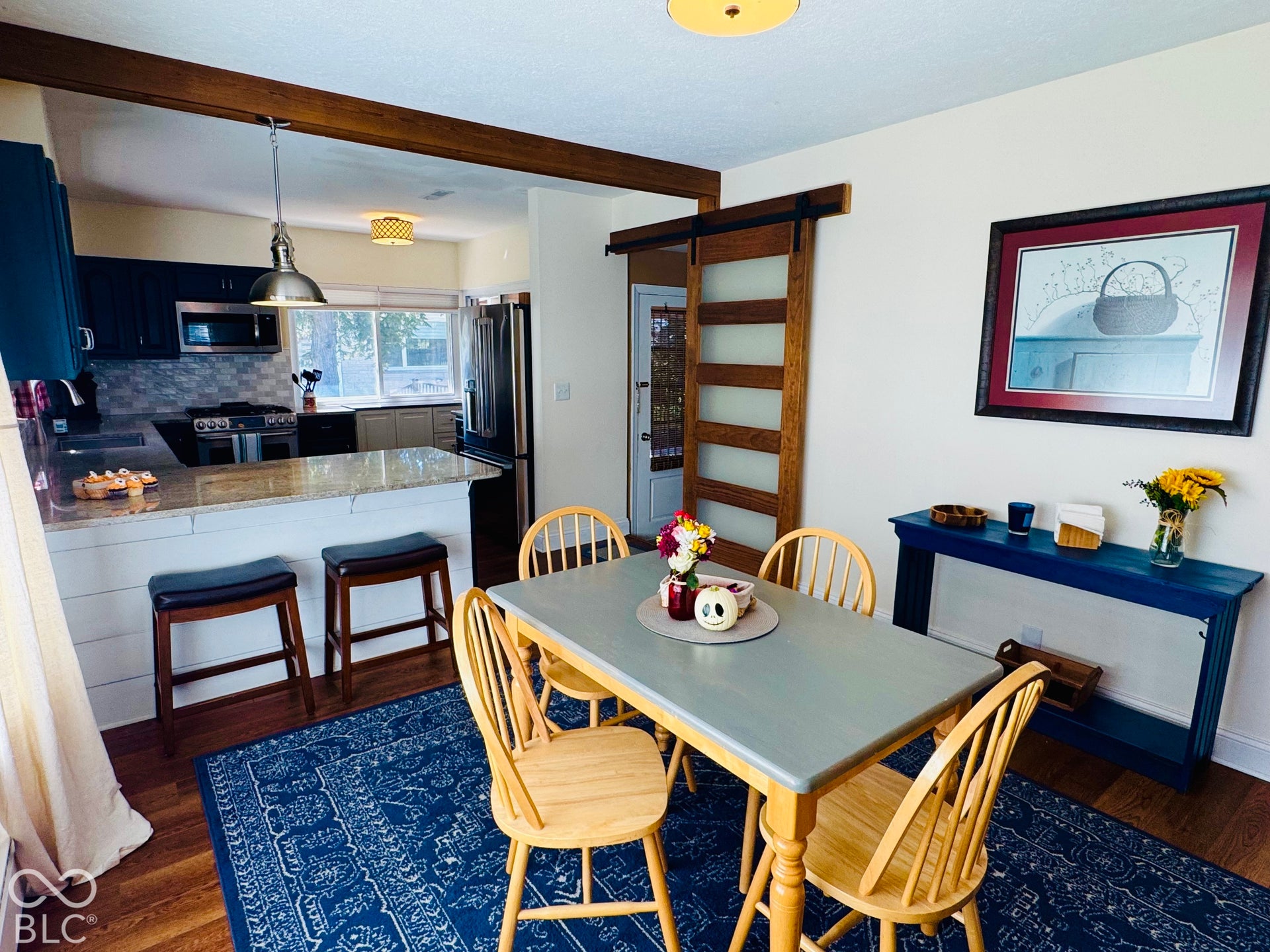 Kitchen that includes a Breakfast Bar, granite countertops, stainless steel appliances, and a tile backsplash