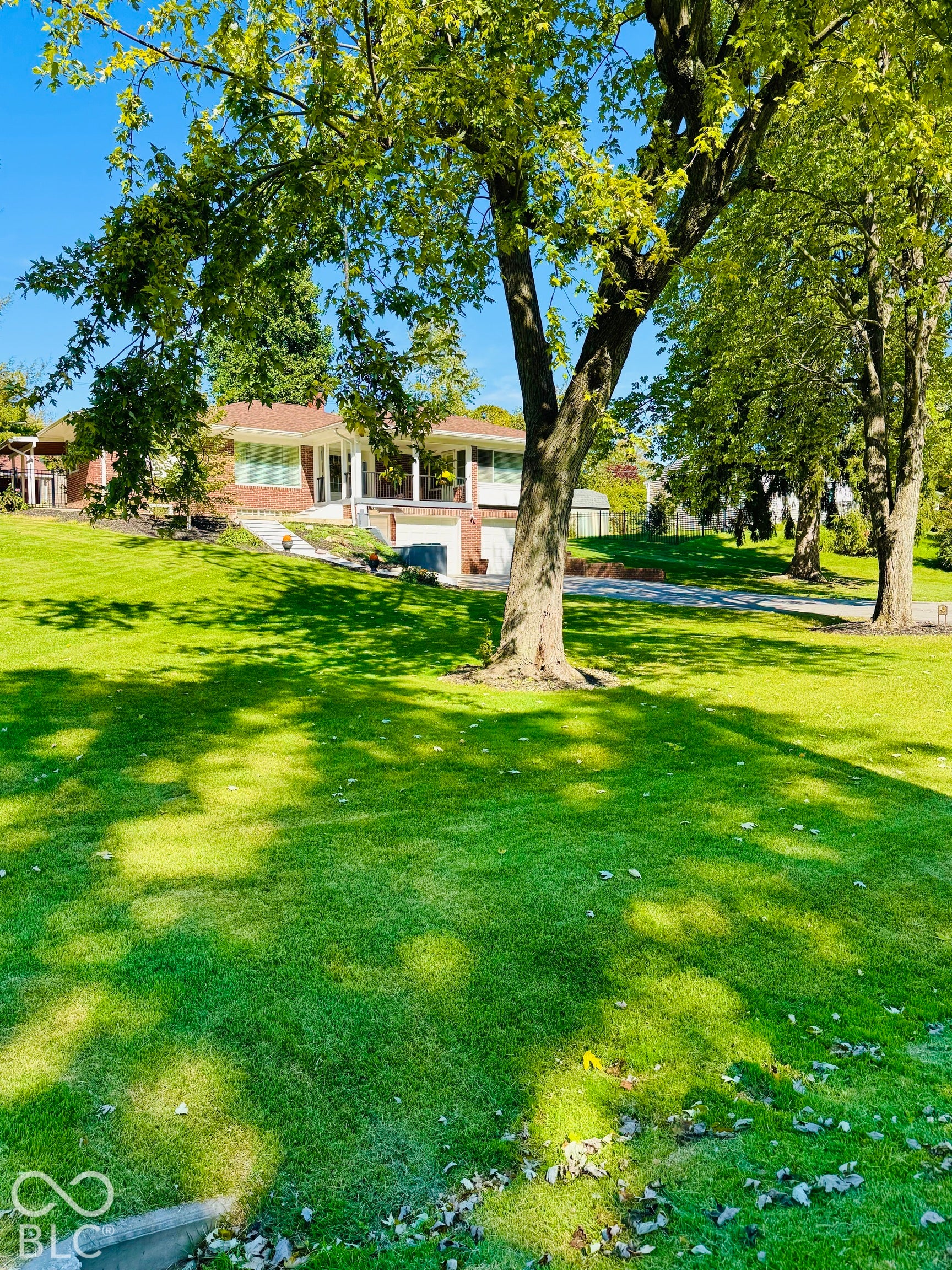 Expansive green lawn with mature trees