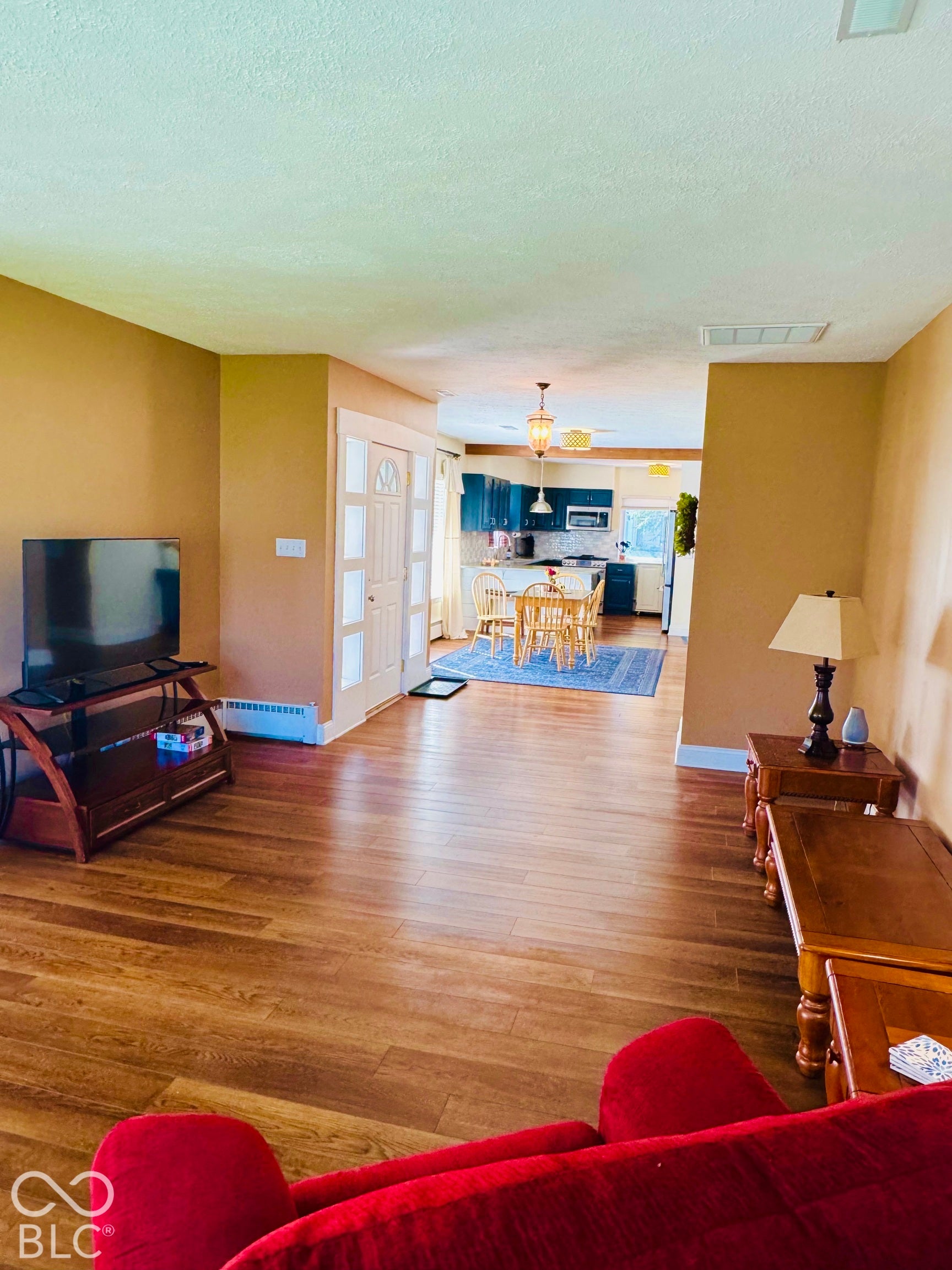 Beautiful Vinyl Hardwood-finish flooring throughout, entryway door with decorative glass inserts, and recessed lighting open to Kitchen and office