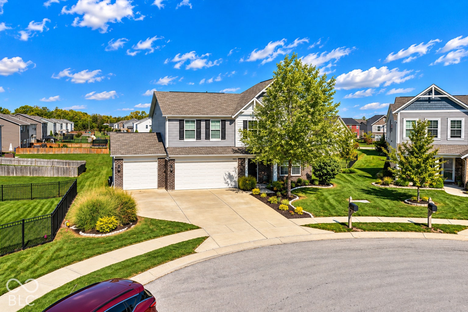 *AI - Color Enhancement* Two-story residence featuring light gray siding with dark shutters, a two-car garage, and a concrete driveway